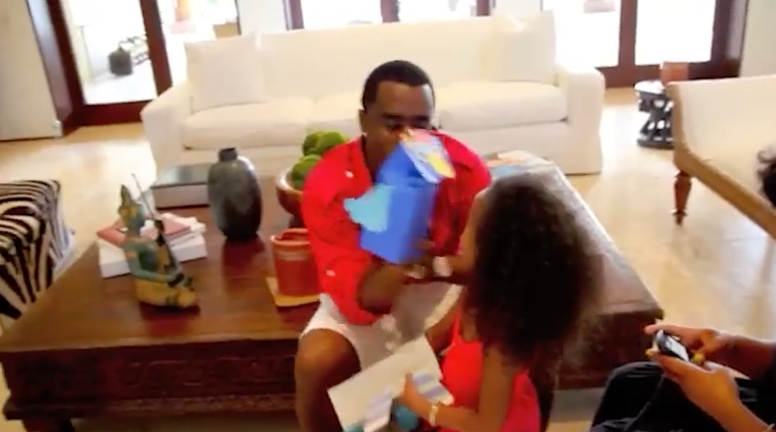 Combs is seeing playing with one of his children in the 11-minute video