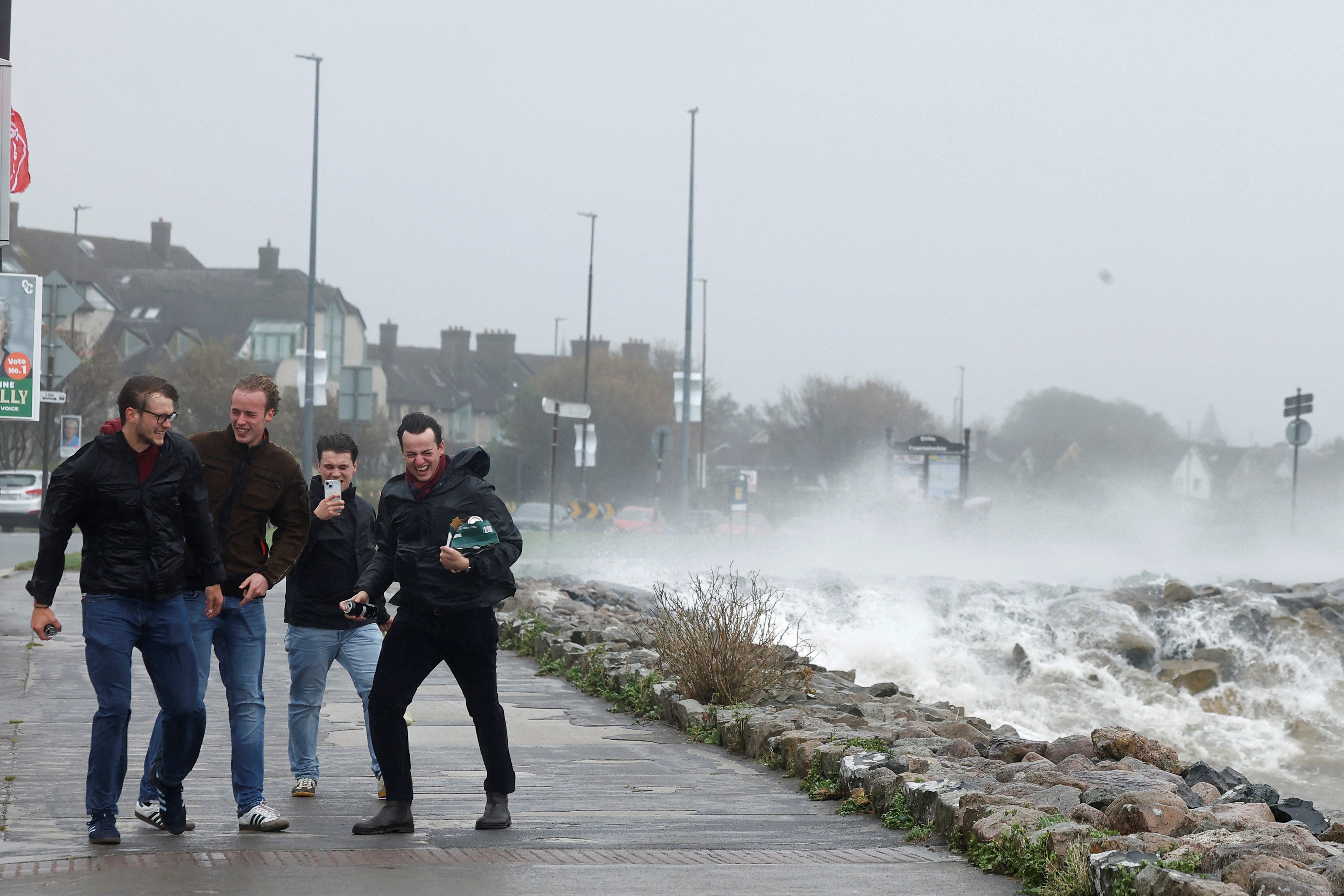 People try to walk in gale force wind during Storm Amy in Galway, Ireland
