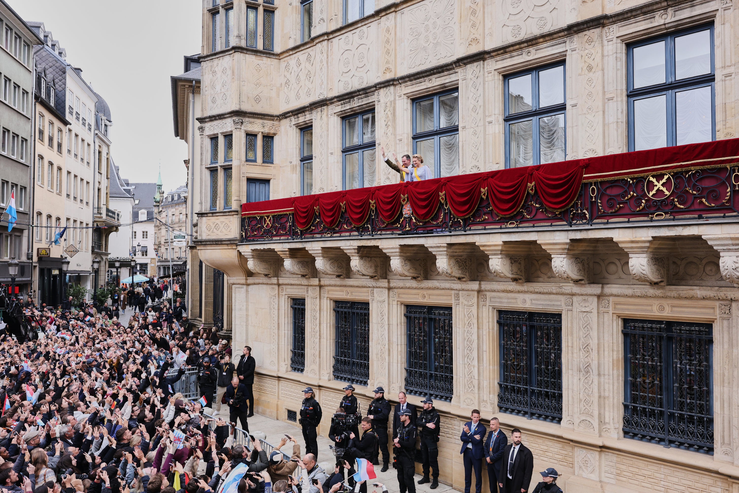 Luxembourg's Grand Duke Guillaume and Luxembourg's Grand Duchess Stephanie wave from the balcony of the Grand Ducal Palace in Luxembourg