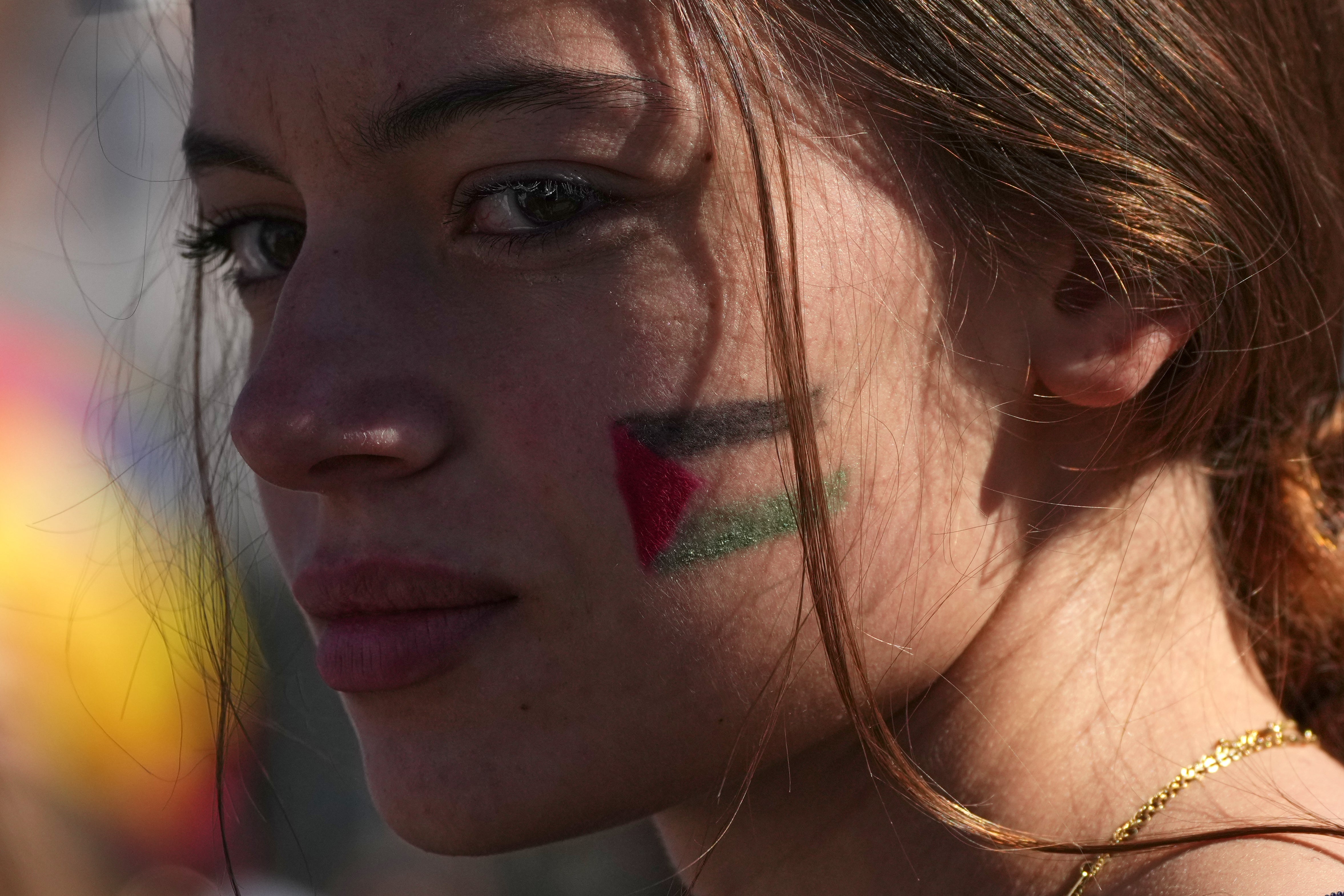 A pro-Palestinian demonstrator gathers for a national general strike called by different unions to protest against the situation in Gaza two days after Israeli forces intercepted a Gaza-bound aid flotilla in the Mediterranean Sea, in Rome, Friday, Oct. 3, 2025. (AP Photo/Alessandra Tarantino)
