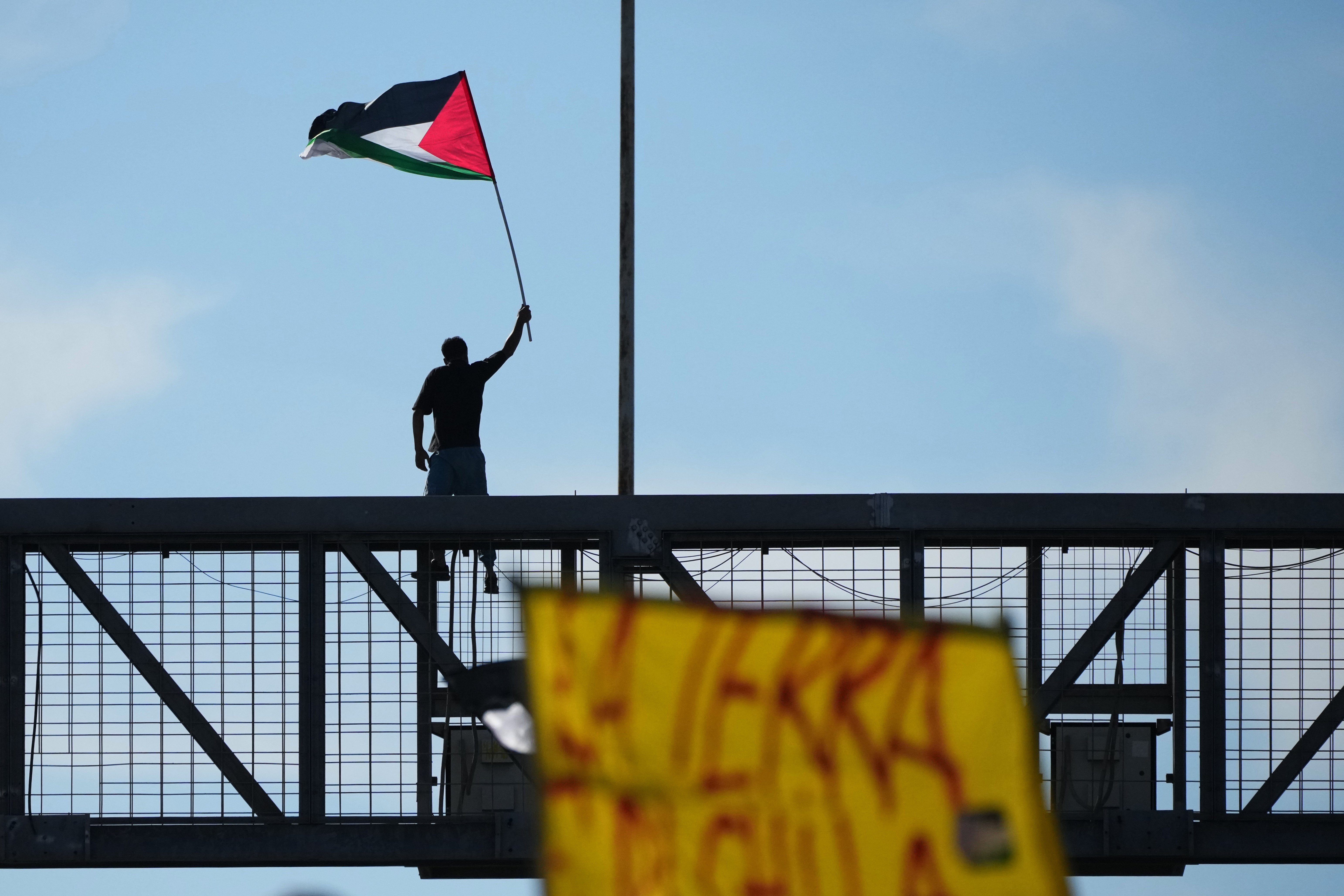 A pro-Palestinian demonstrator protests along the Rome's ring road as they gather for a national general strike