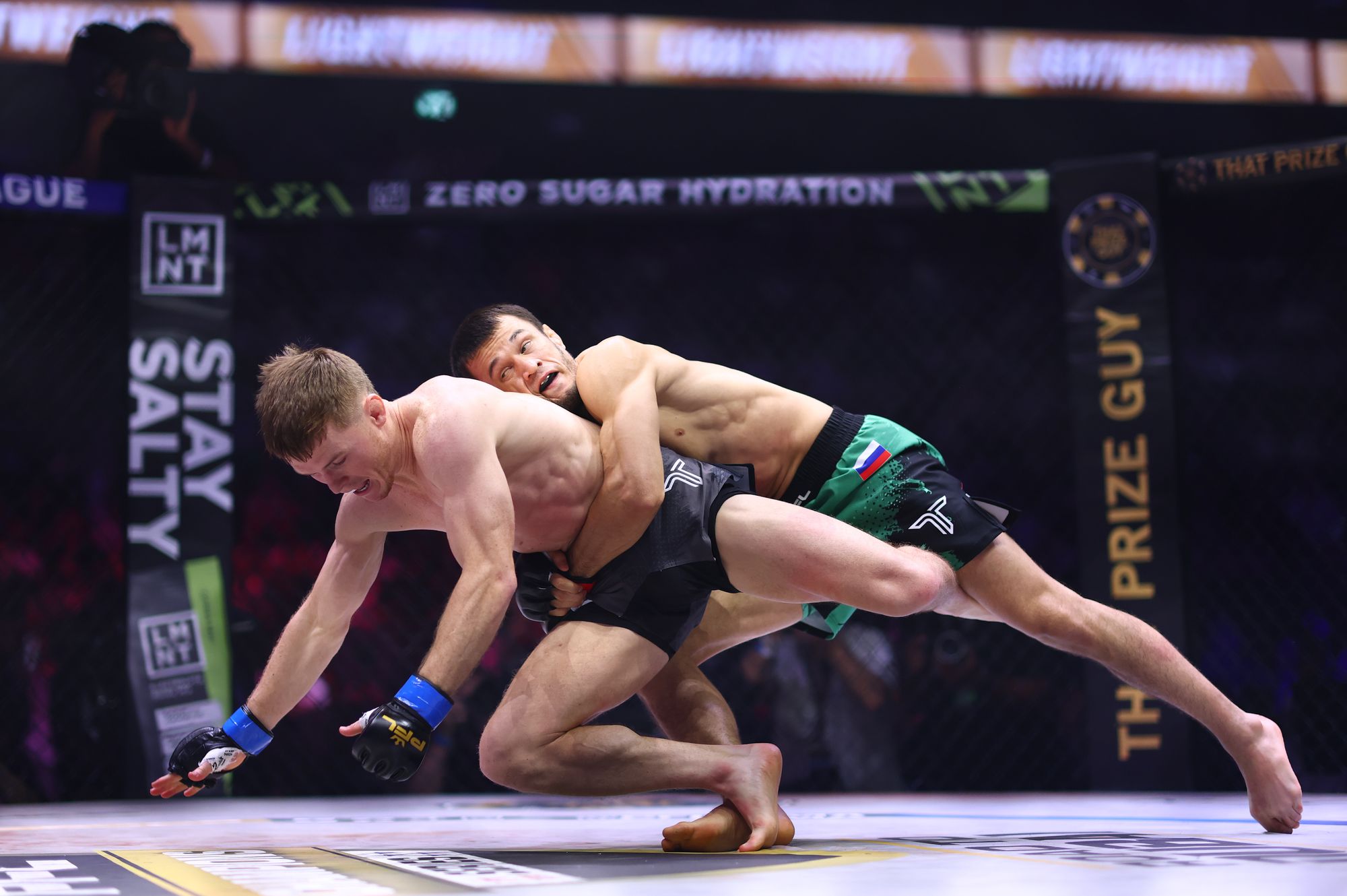 <p>Usman Nurmagomedov (right) took down Paul Hughes intermittently but could not keep him down</p>