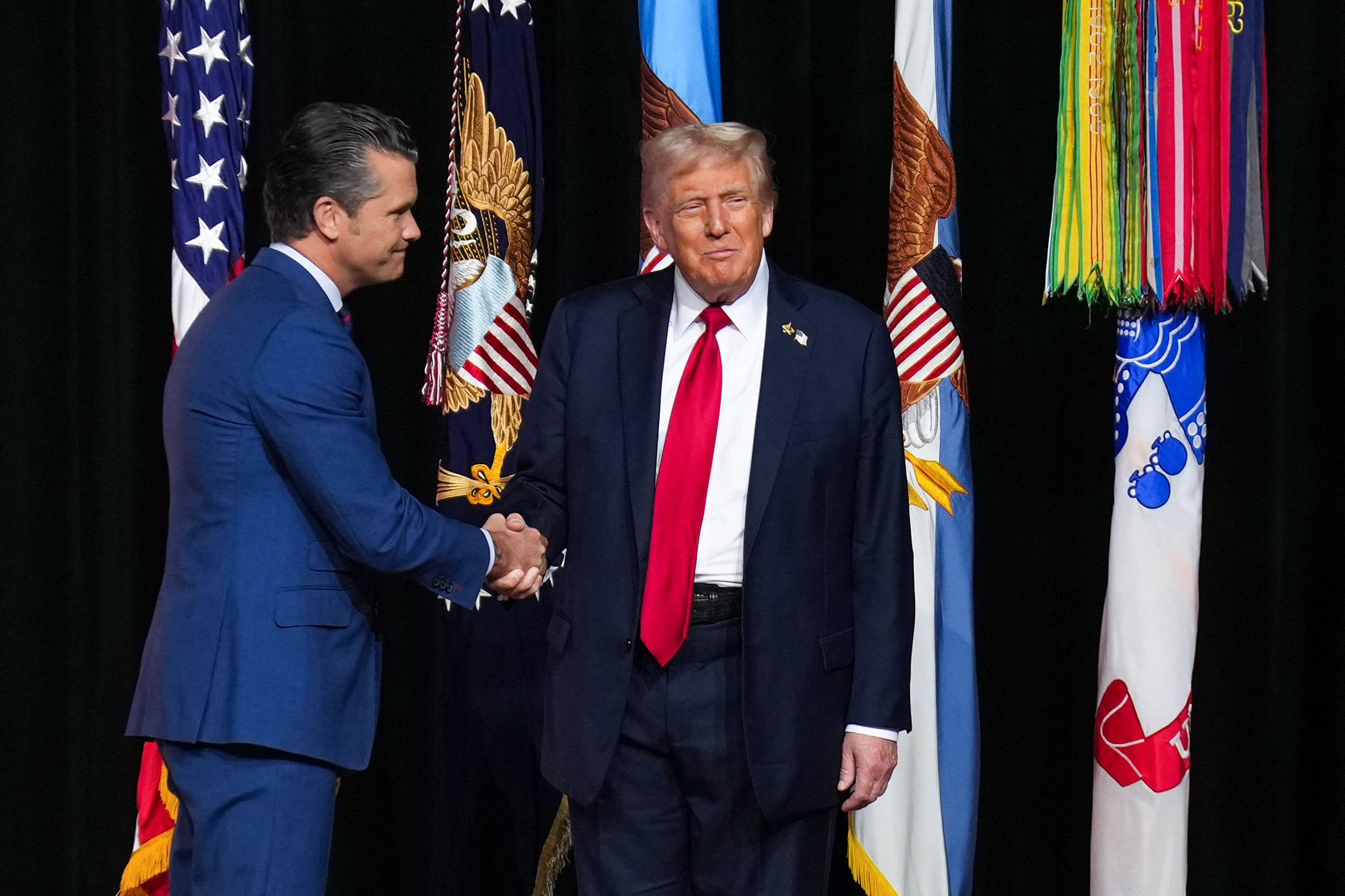 Secretary of War Pete Hegseth shakes hands with President Donald Trump in Quantico, Virginia, on Tuesday