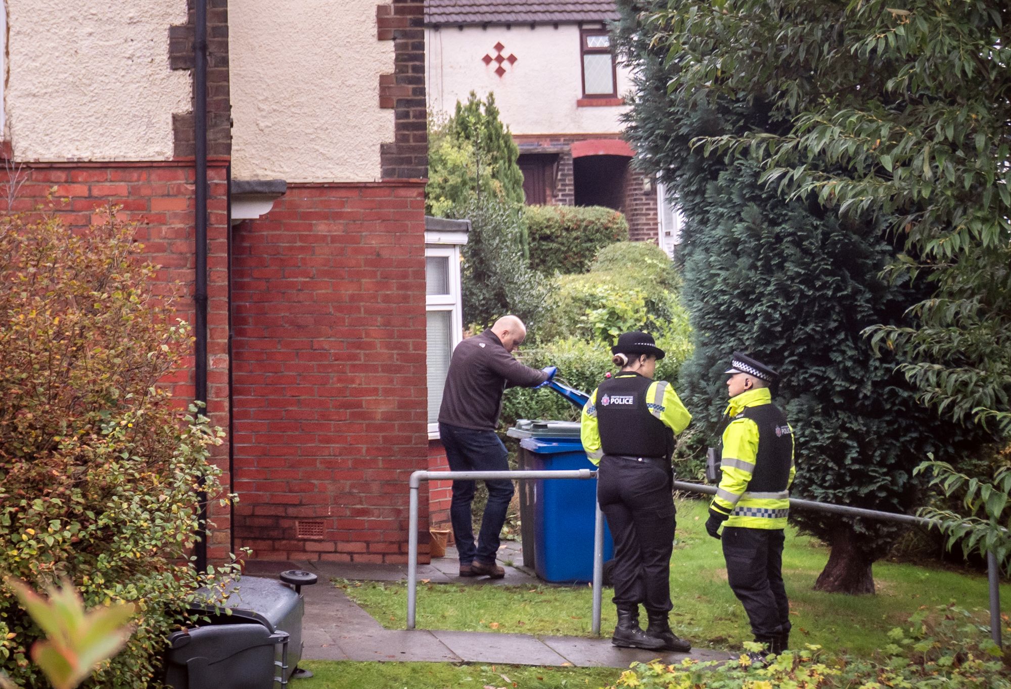 Police stand outside a home connected with the terror attack at the Hebrew Congregation synagogue in Crumpsall