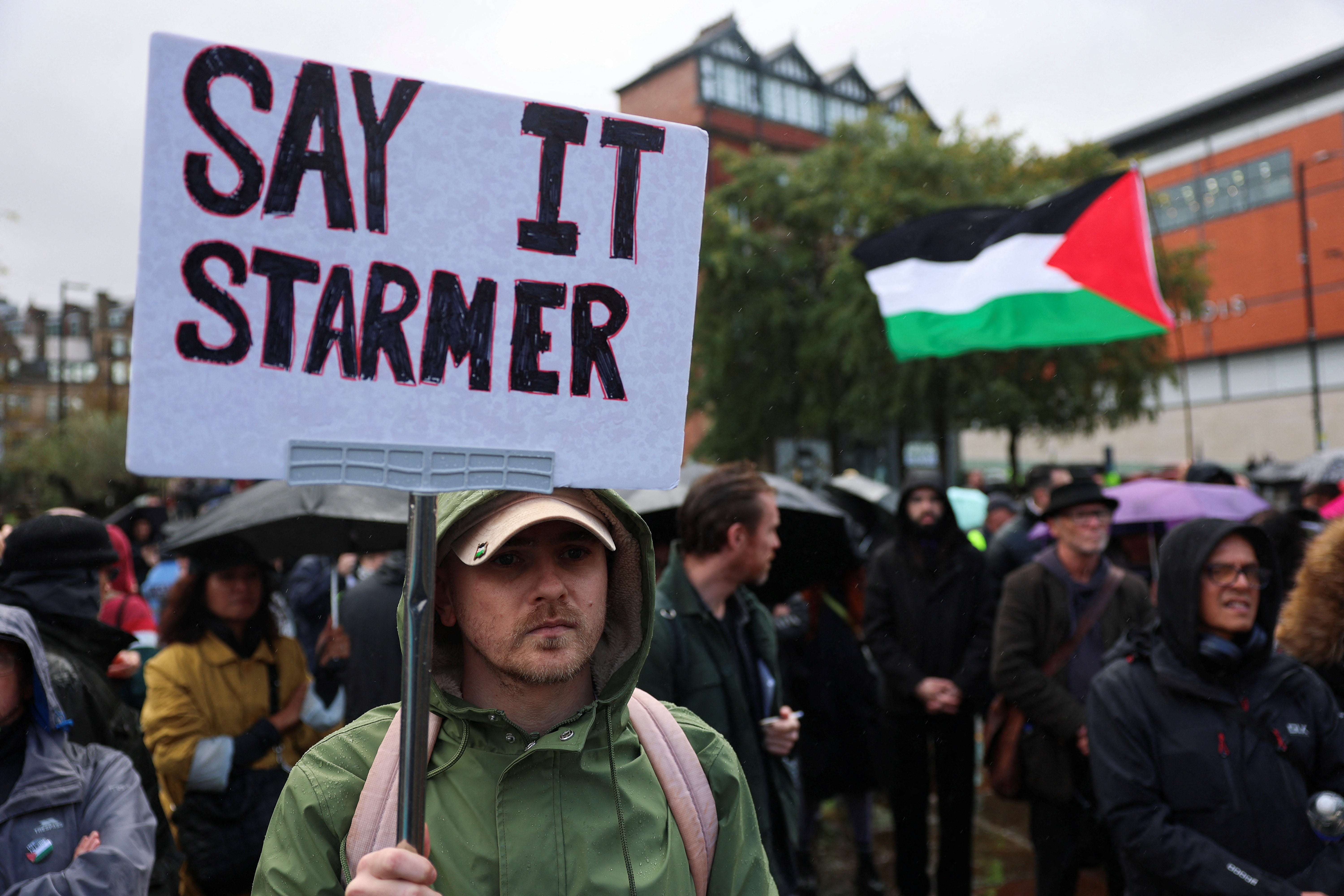 A protester holds a sign during a demonstration in Manchester calling for an end to Israeli occupation
