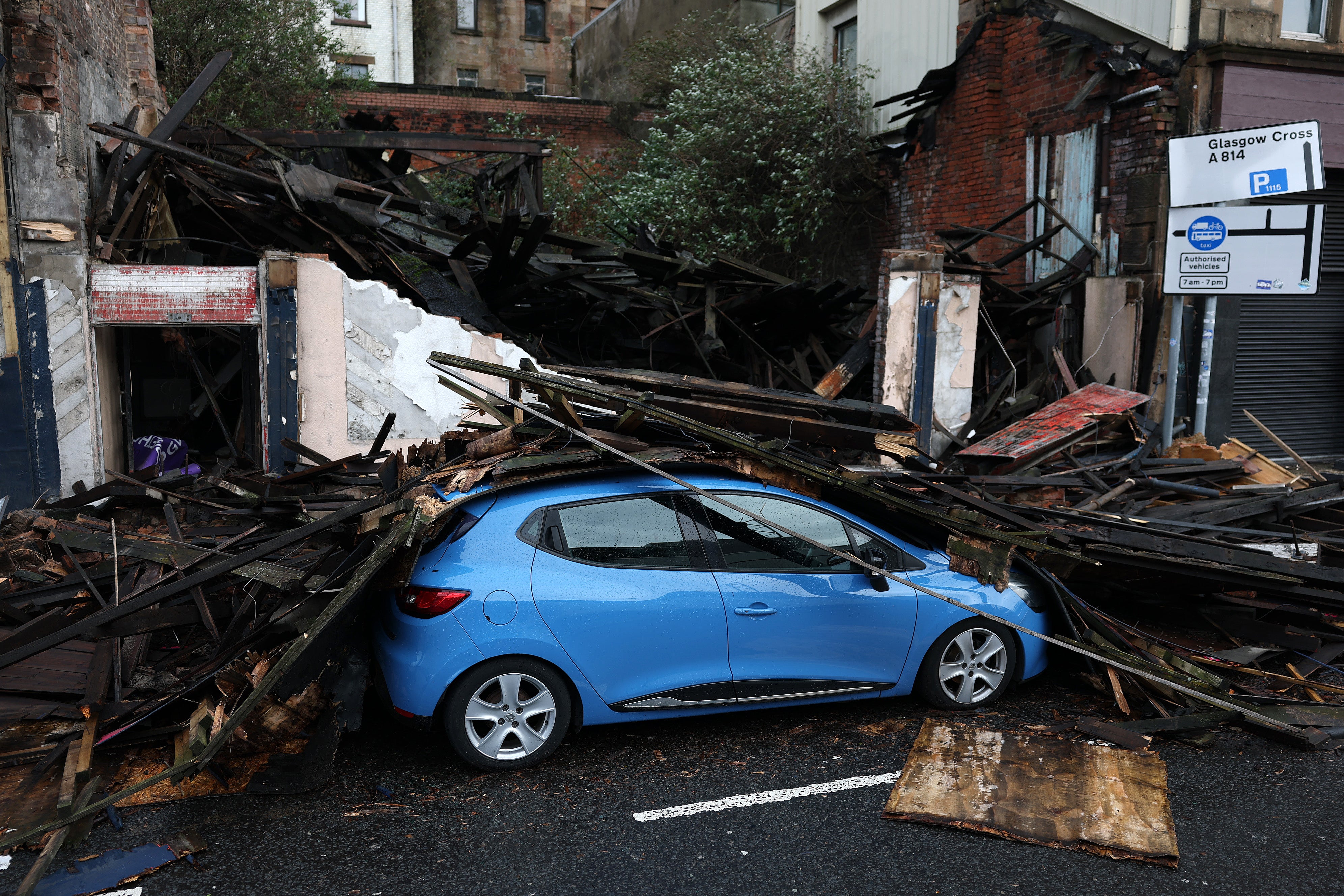 Debris from a collapsed building falls on a car in Broomielaw in Scotland, with the country seeing the worst of the weather
