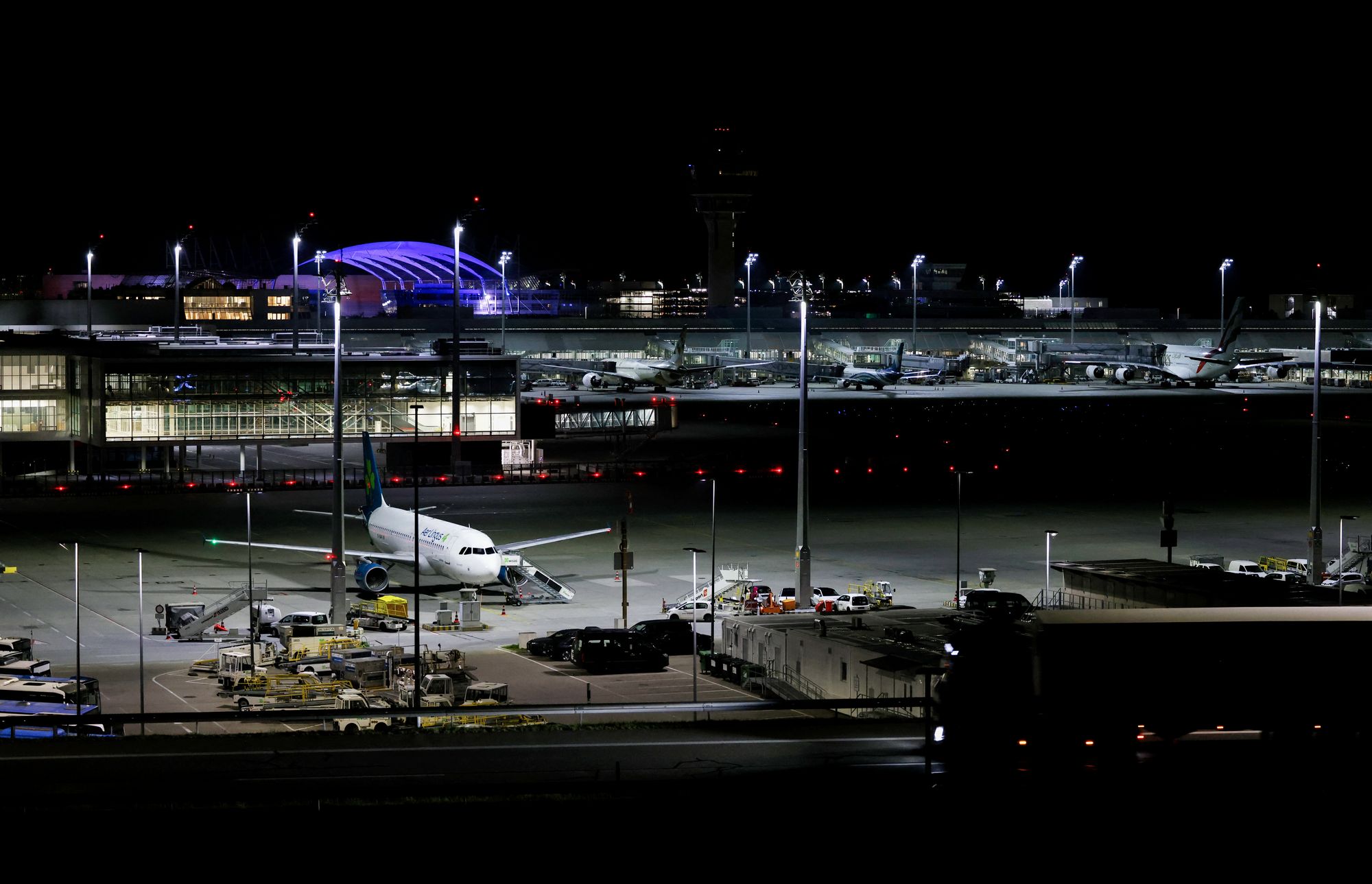 Night view shows an Airlingus plane grounded at Munich International Airport in Munich, southern Germany, on early 4 October 2025