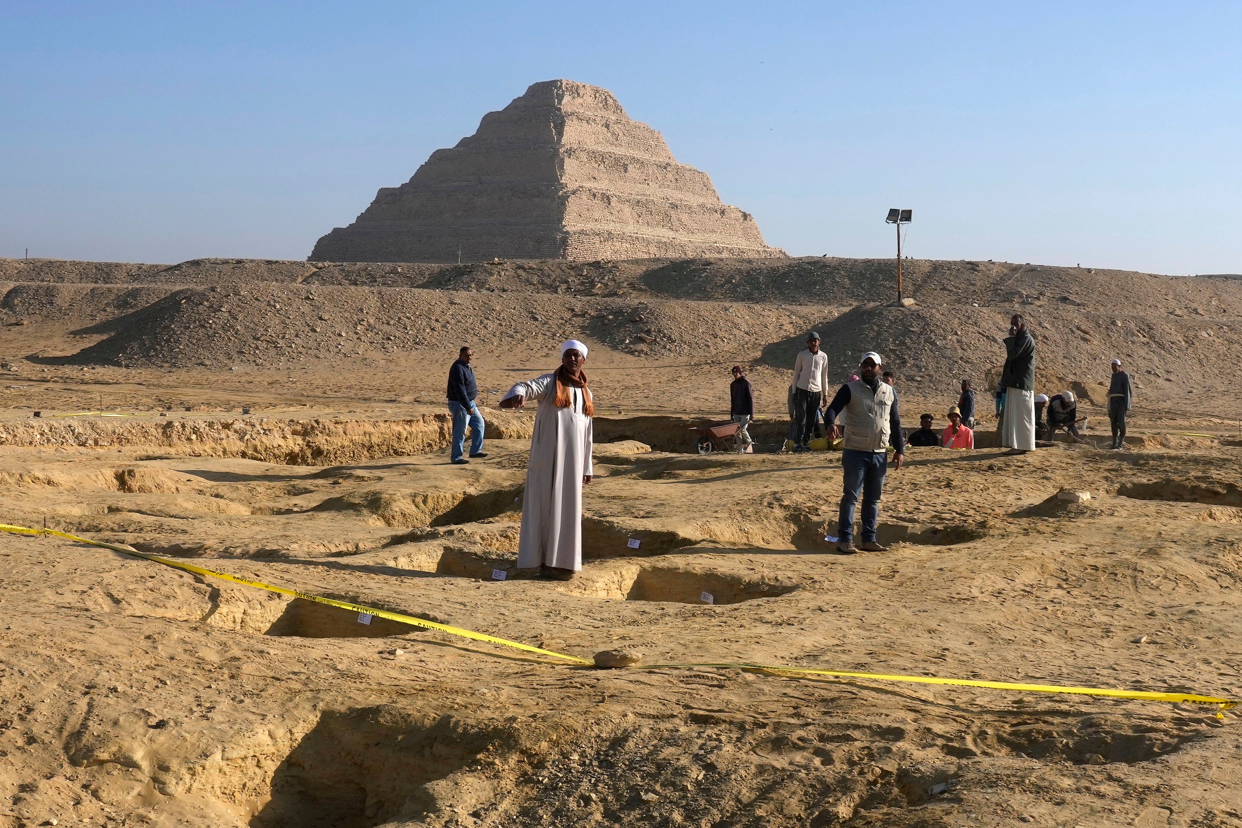 Archaeologists work near the Saqqara site