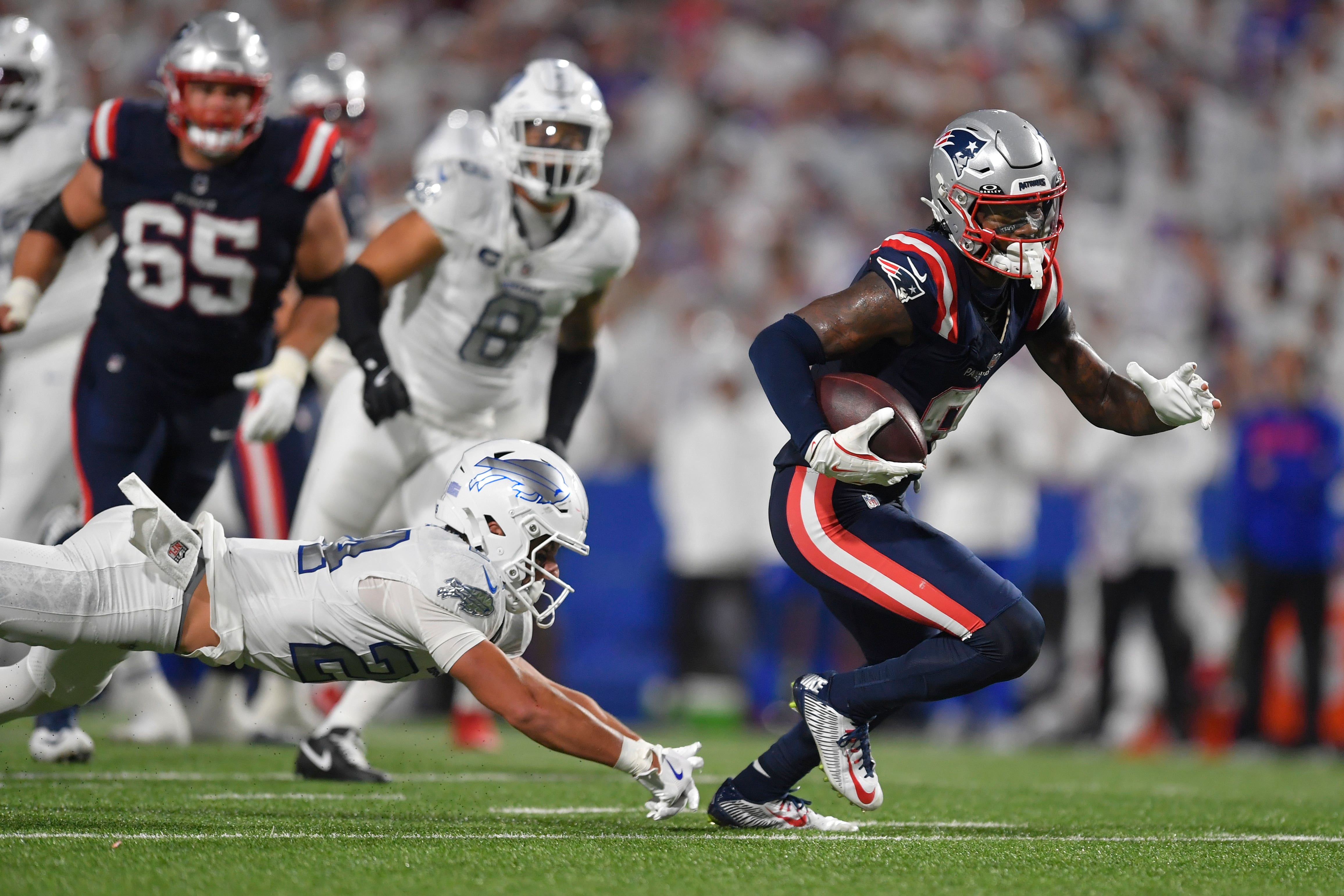 New England Patriots wide receiver Stefon Diggs, right, runs past Buffalo Bills safety Cole Bishop (Adrian Kraus/AP)