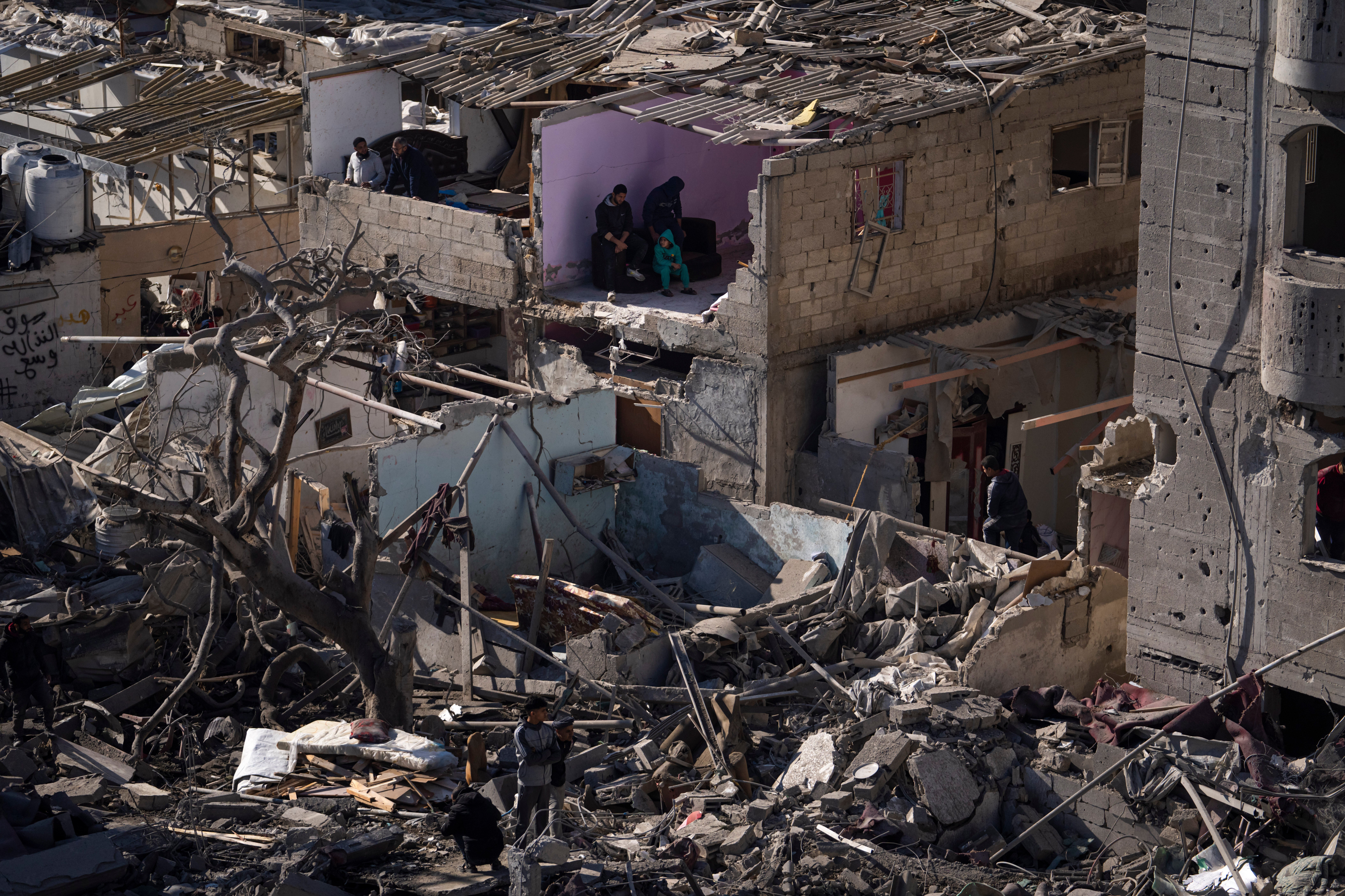 People survey the destruction after an Israeli strike on buildings and a mosque in Rafah, Gaza, in February last year