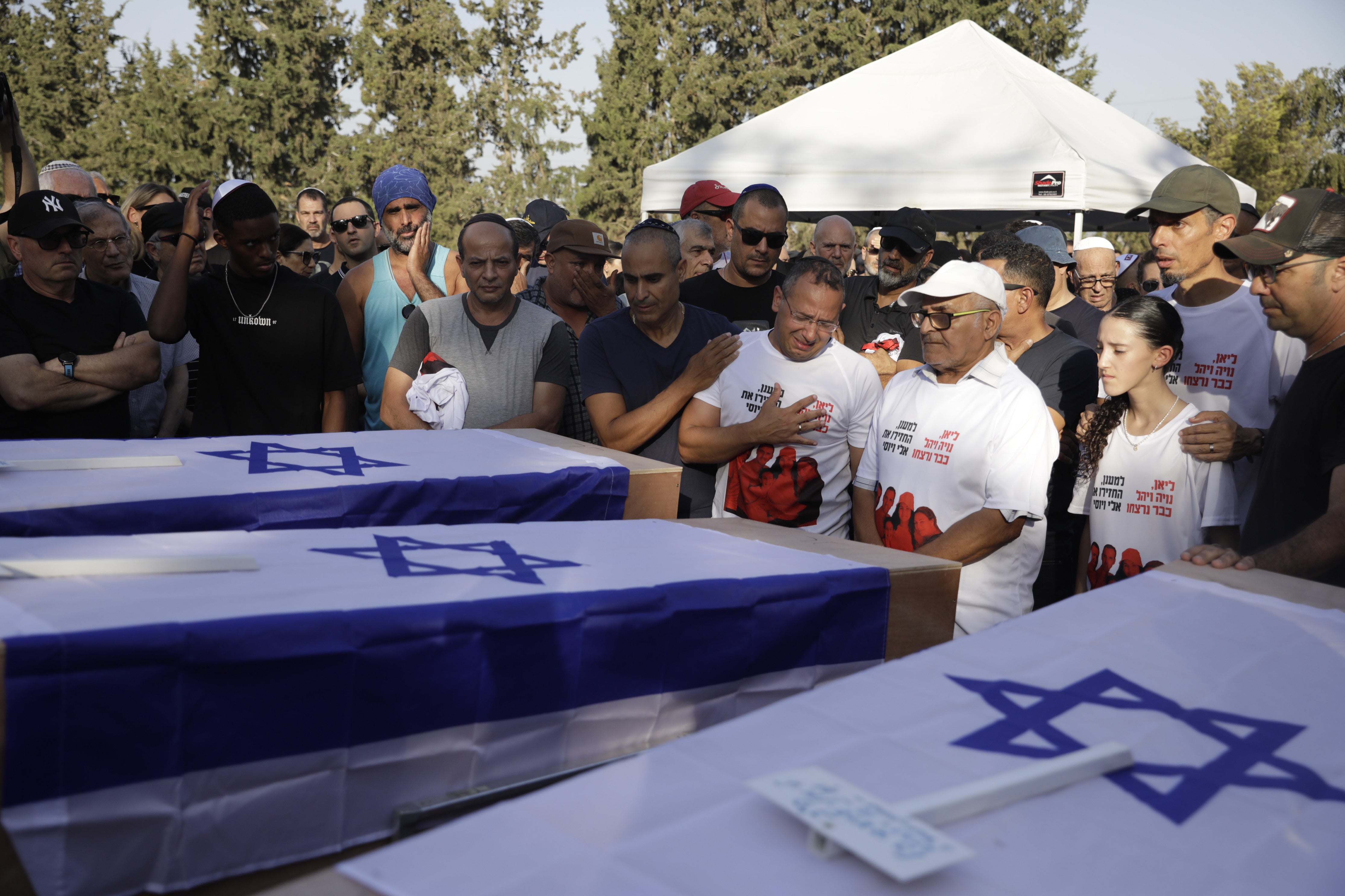 Mourners attend the funeral for members of the Sharabi family, who were killed in the attack on Kibbutz Be'eri on 25 October 2023, in Kfar HaRif, Israel