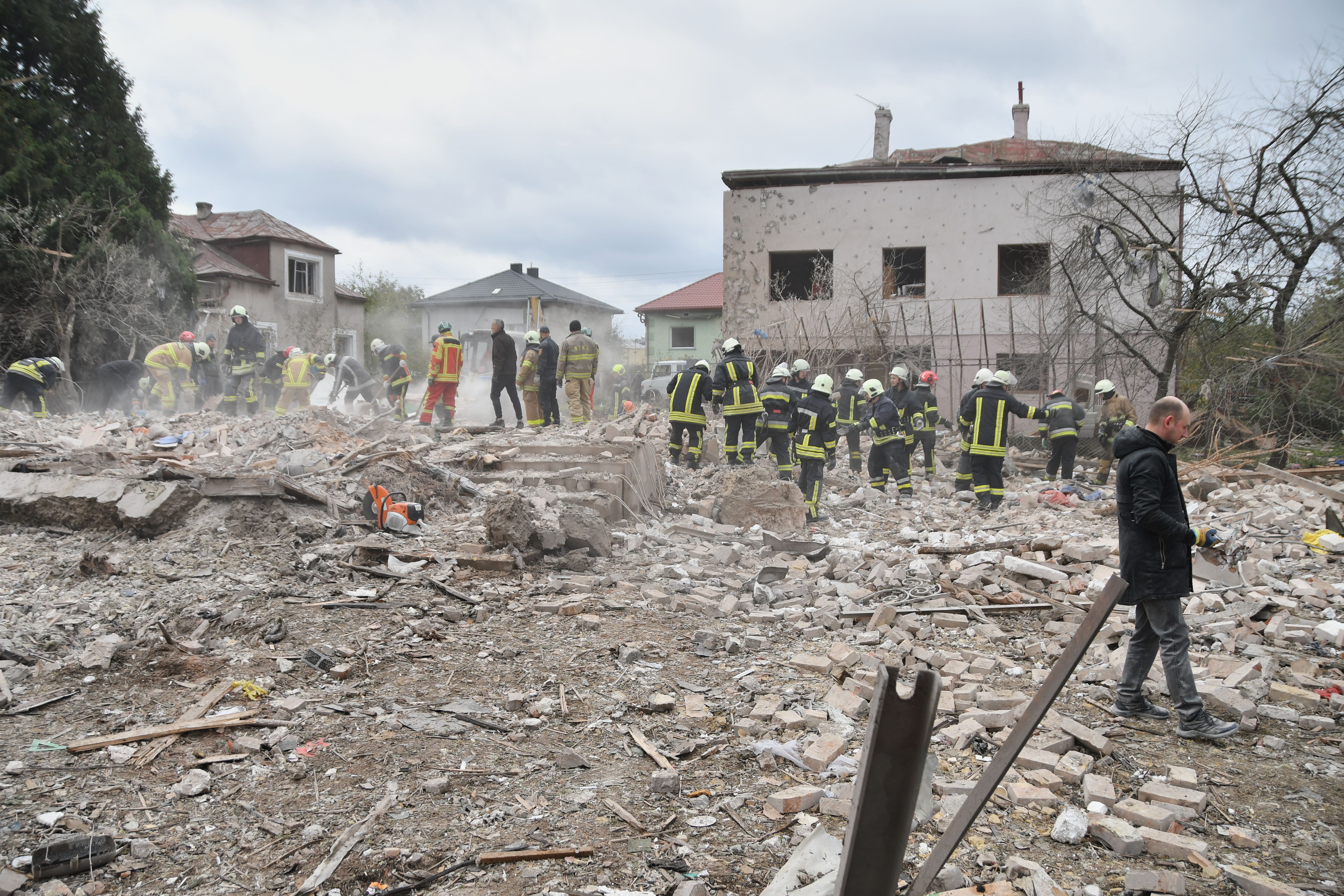Rescuers search for victims in the debris after a Russian strike on Lviv