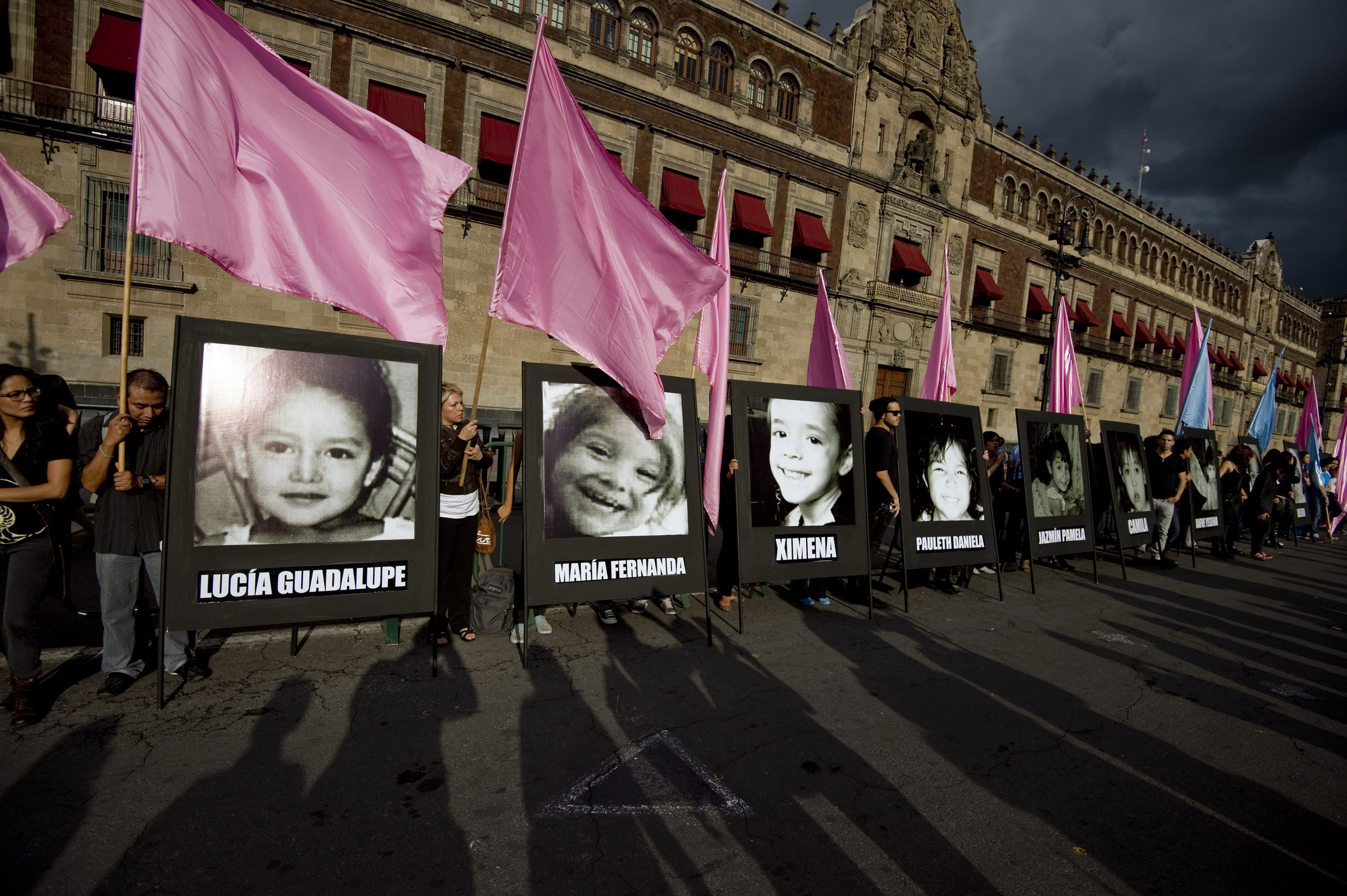 Relatives of the 49 children who died in a fire at a daycare centre in Hermosillo in 2009 demonstrate with the portrait of the victims to demand justice