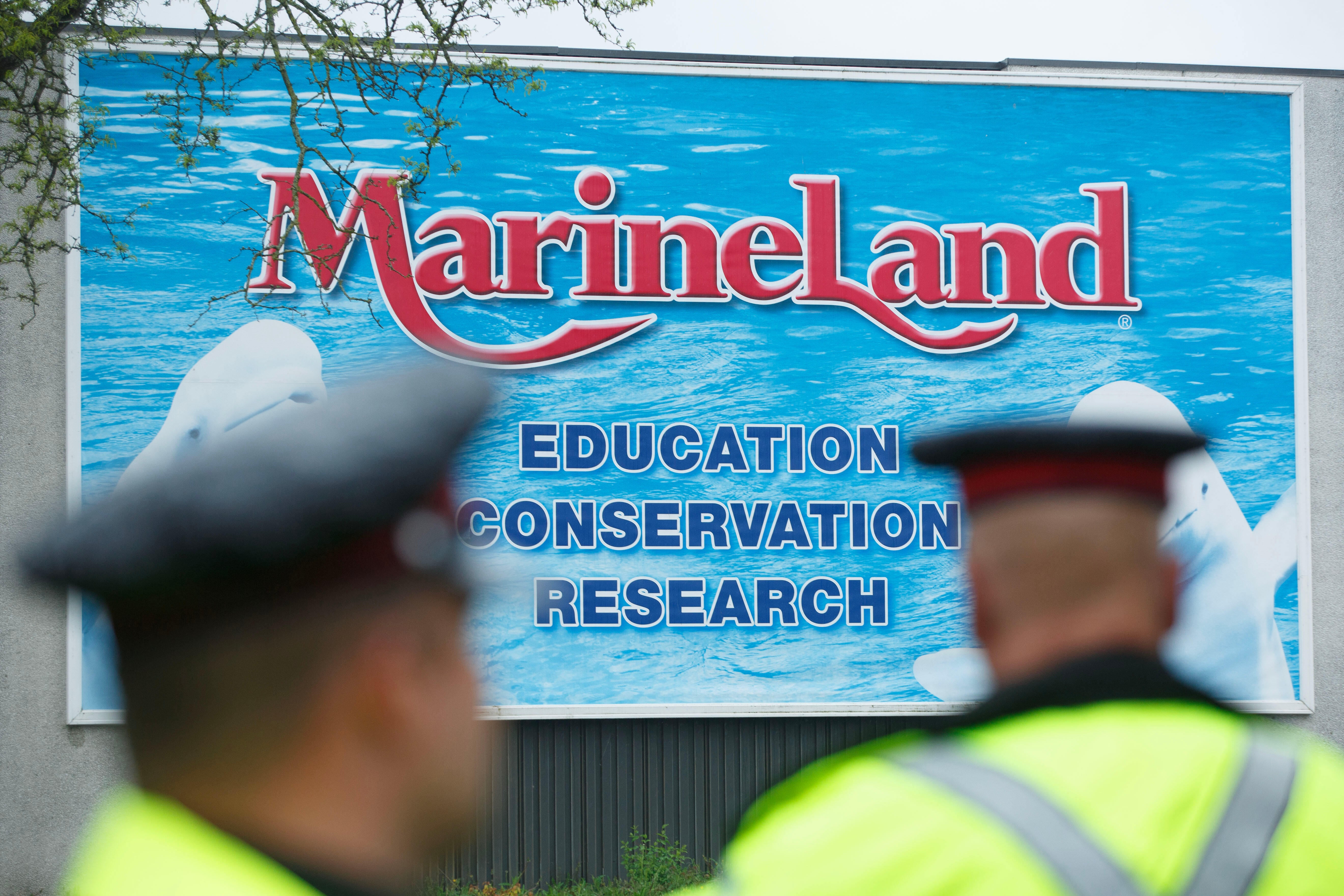 Police officers block protesters from an entrance to Marineland grounds in Niagara Falls, Ontario, Canada, in May 2023