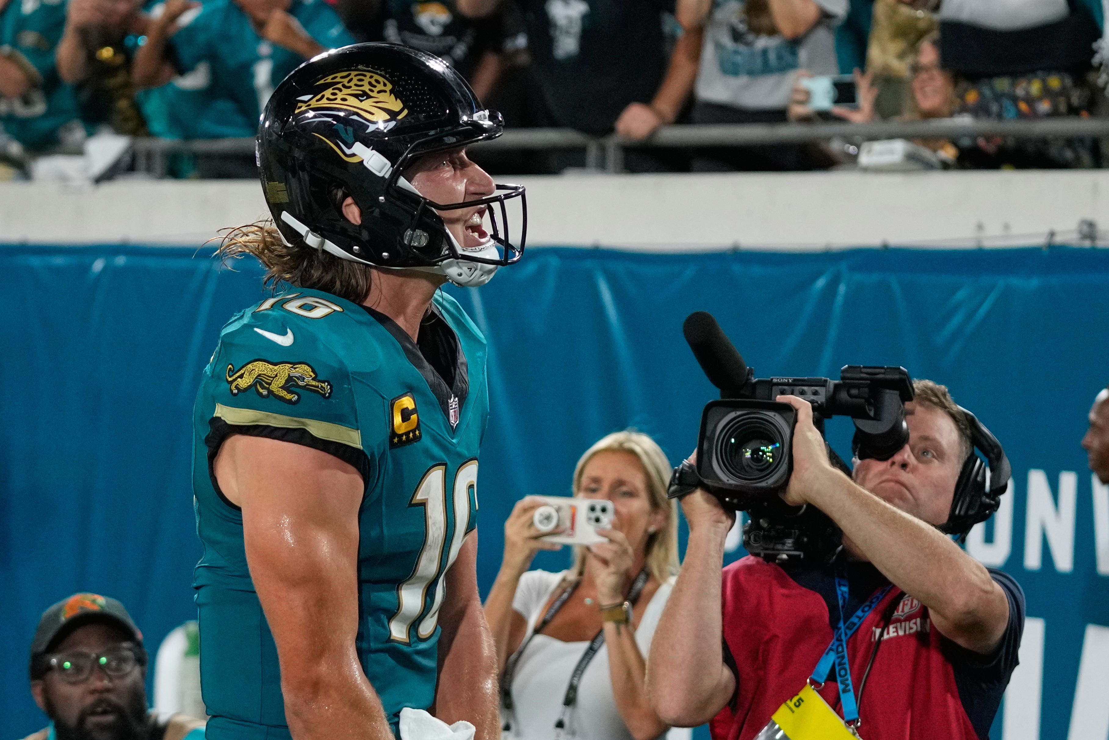 Jacksonville Jaguars quarterback Trevor Lawrence celebrates after scoring a touchdown (John Raoux/AP)