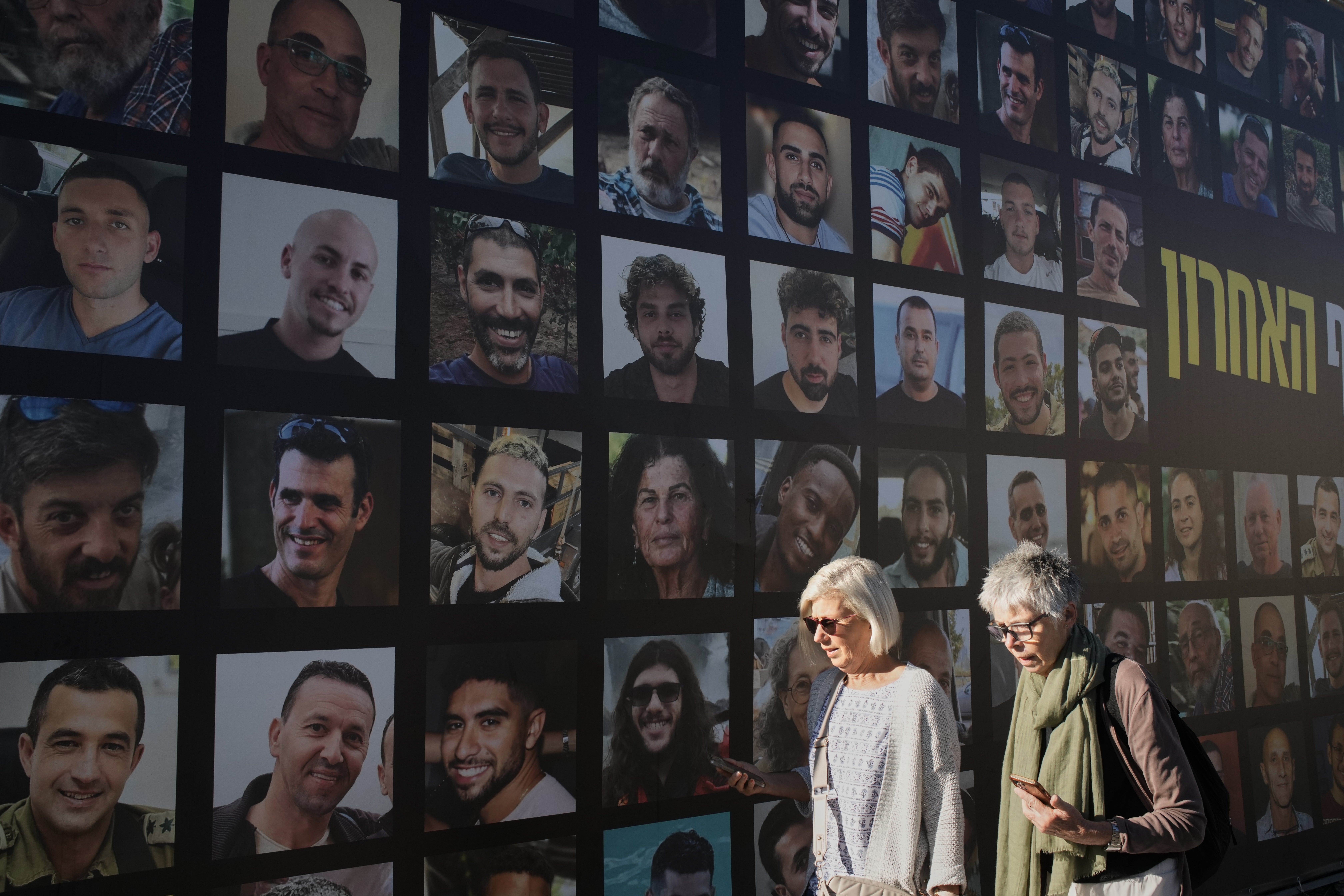 A banner in Jerusalem on Tuesday shows photographs of hostages who were kidnapped and held by Hamas in the Gaza Strip