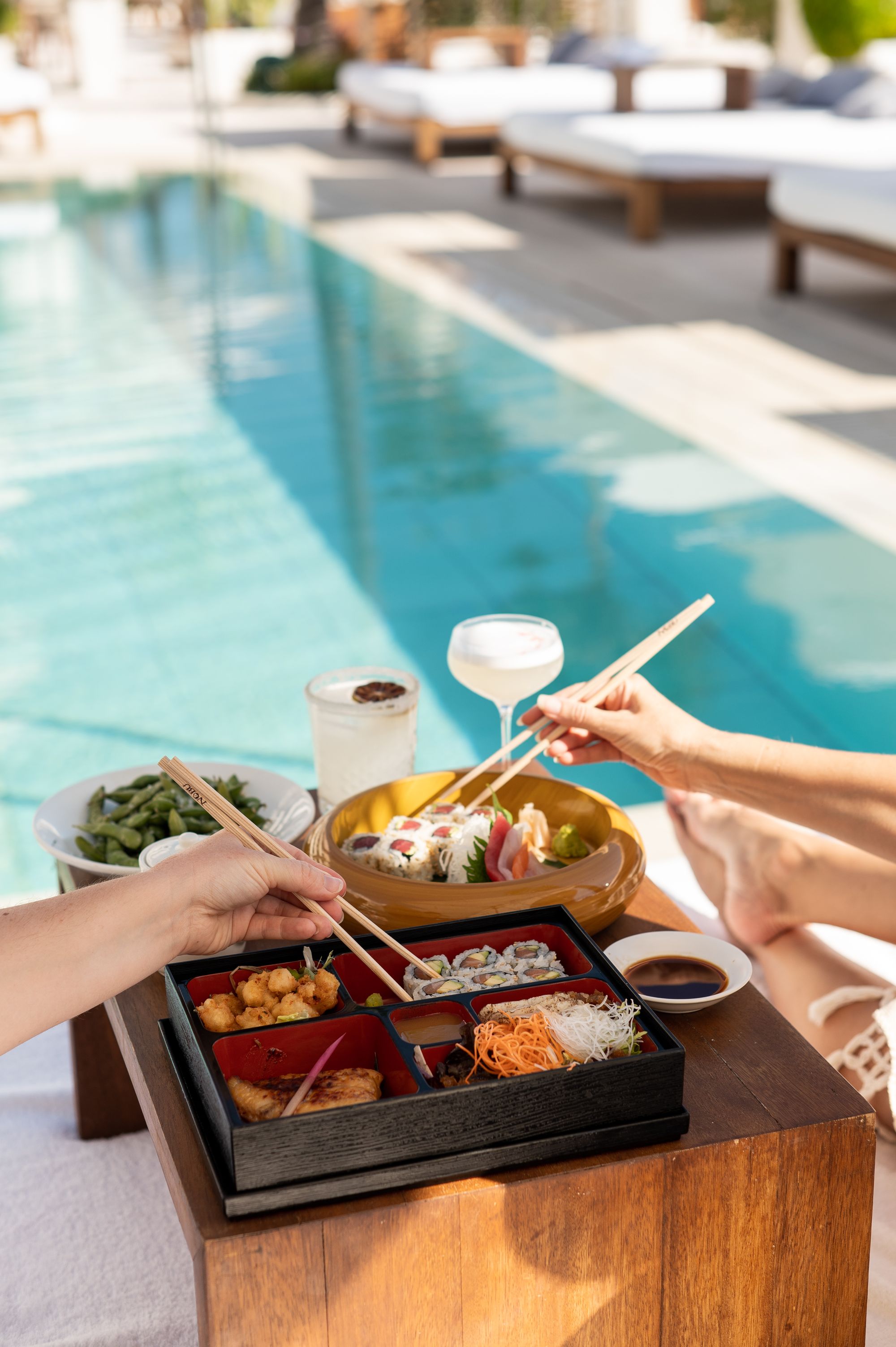 Enjoy sushi and cocktails while lounging around the pool