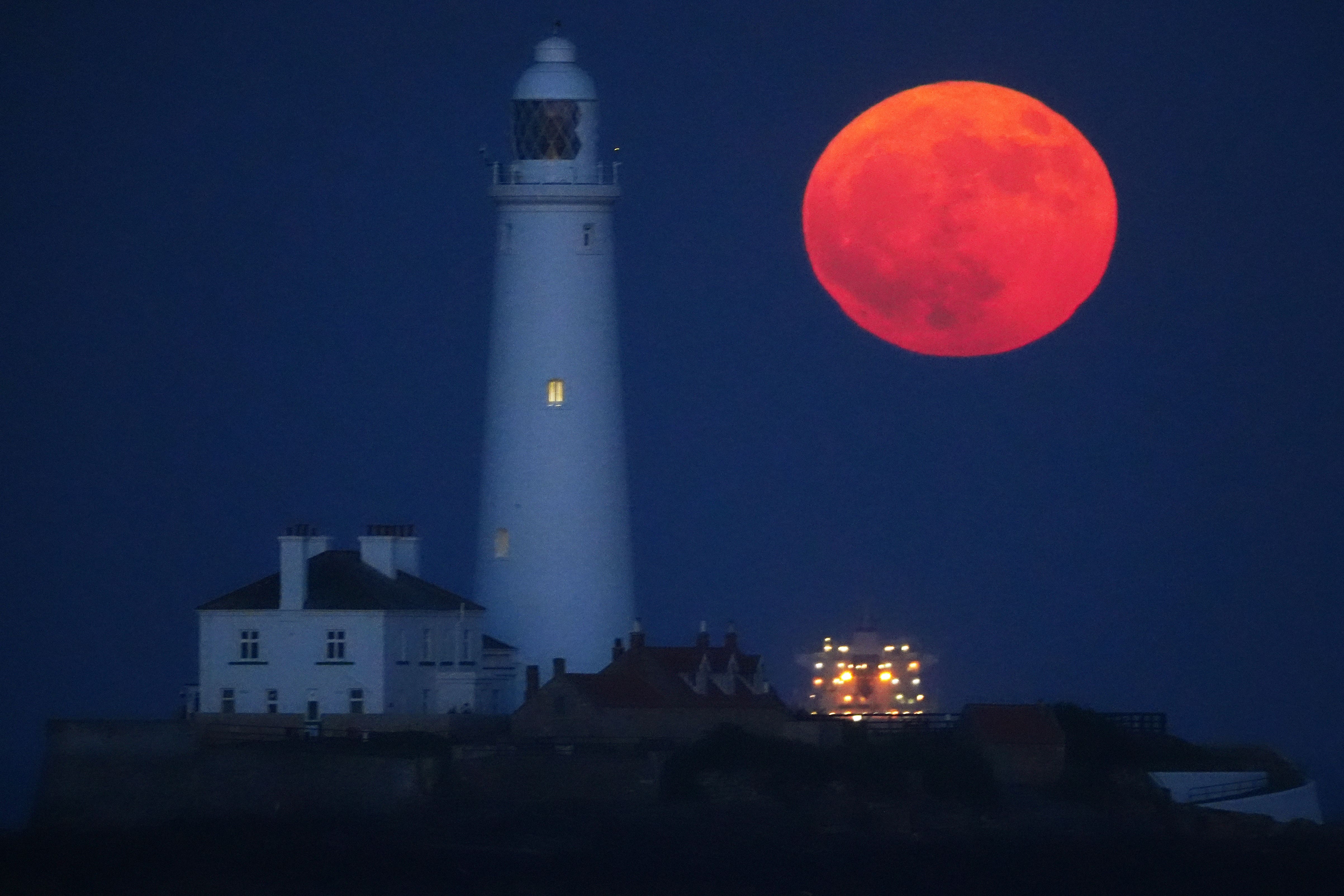 <p>The full moon, also known as the Flower Moon, rises through the sea mist at St Mary’s Lighthouse in Whitley Bay. on the north-east coast of England</p>