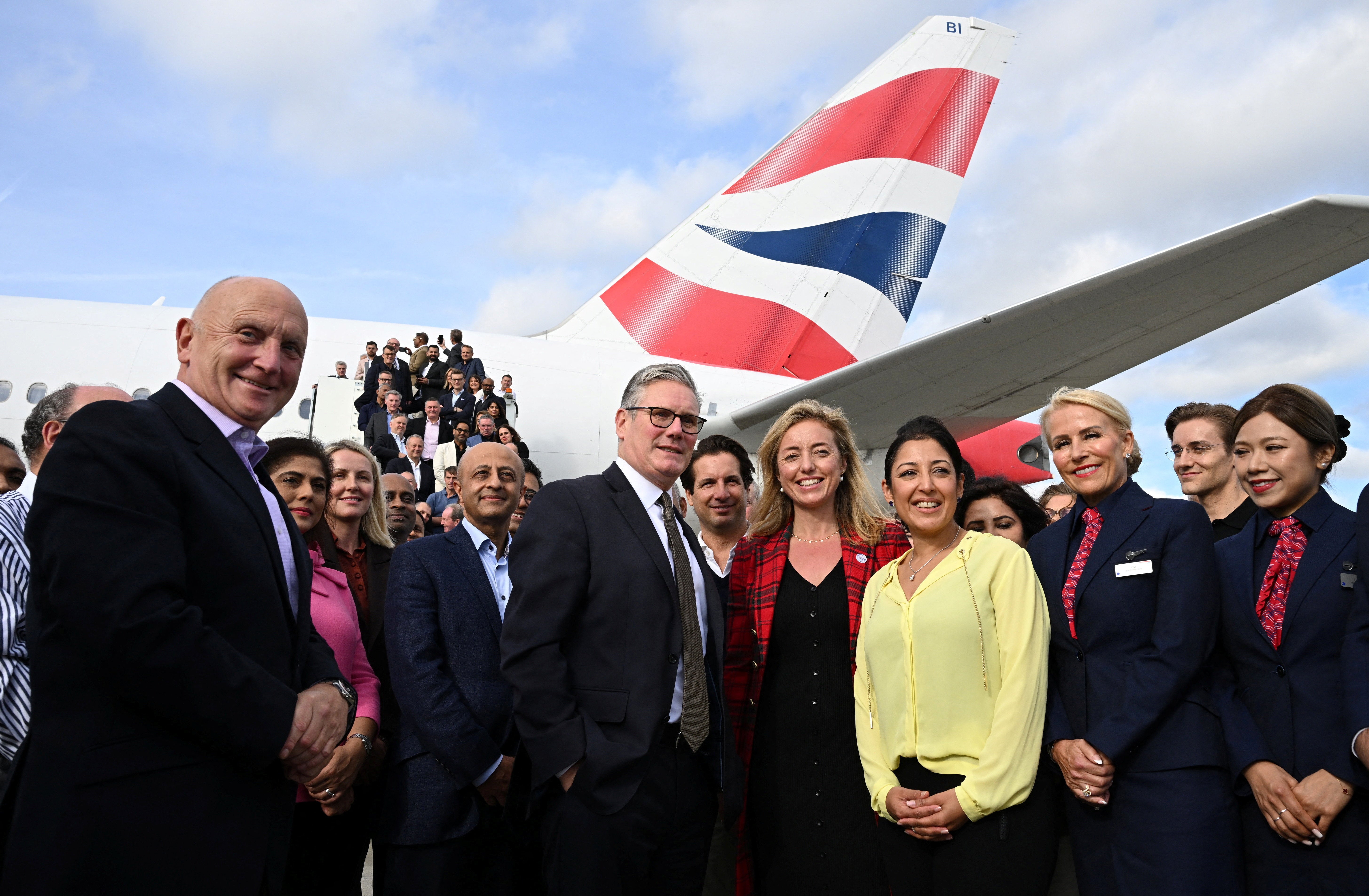 Starmer poses with business leaders before jetting to India