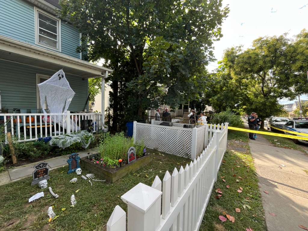 Neighboring houses adorned with Halloween decorations added to the eerie scene Tuesday