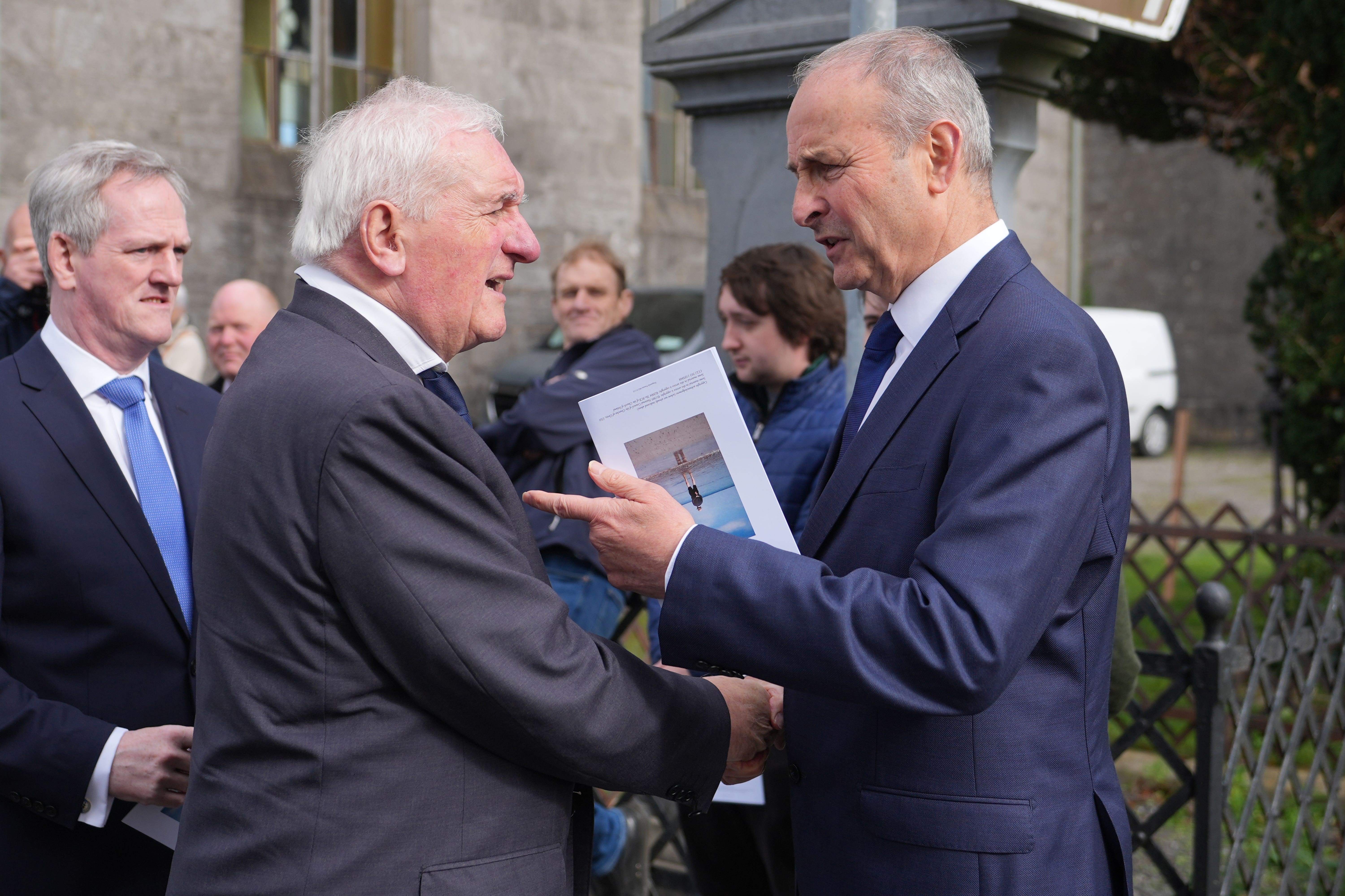 Micheal Martin, right, shakes hands with former taoiseach Bertie Ahern at a funeral mass (Niall Carson/PA)