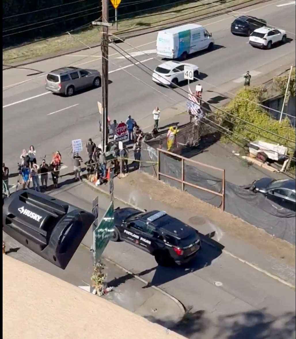 Photographers and protesters gathered outside of an ICE detention facility in Portland to protest the administration's sweeping immigration raids