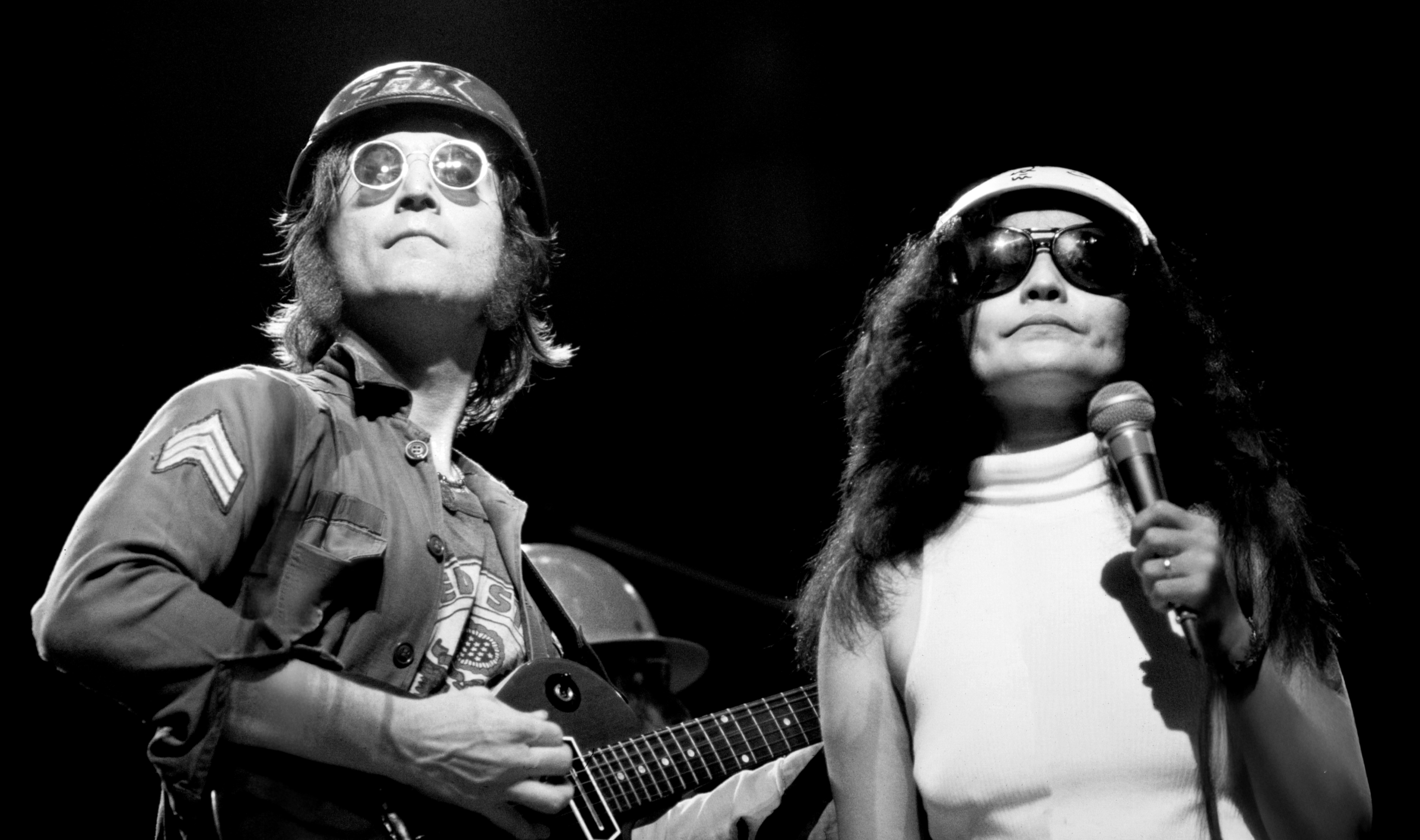 John and Yoko performing together at the benefit gig, photographed by Michael Negrin