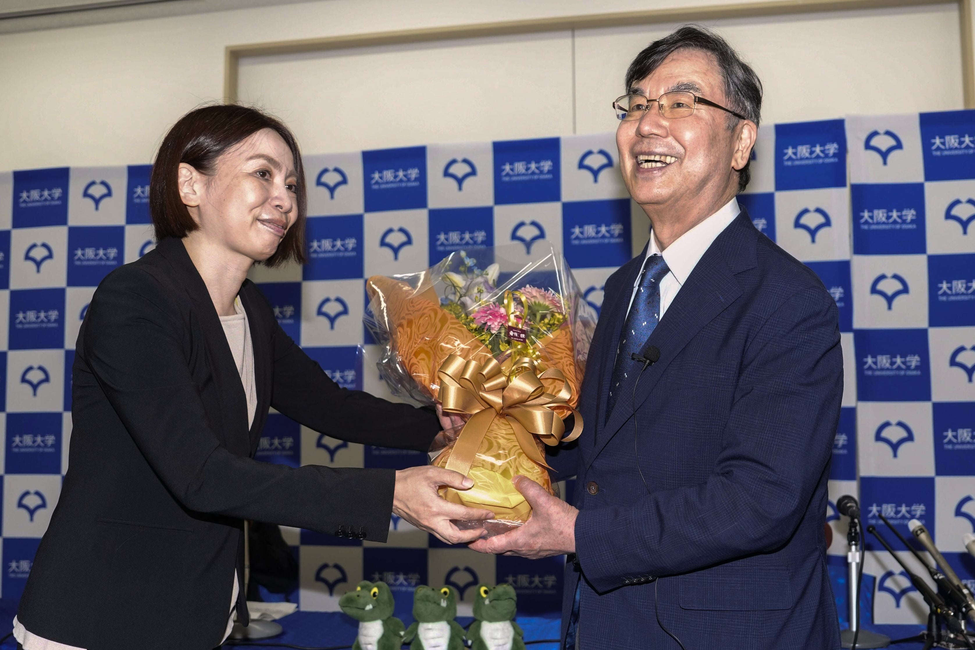 Osaka University professor Dr. Shimon Sakaguchi, right, receives flowers at a news conference in Suita, near Osaka, western Japan, Monday, Oct. 6, 2025, after he won the Nobel Prize in medicine. (Shohei Miyano/Kyodo News via AP)