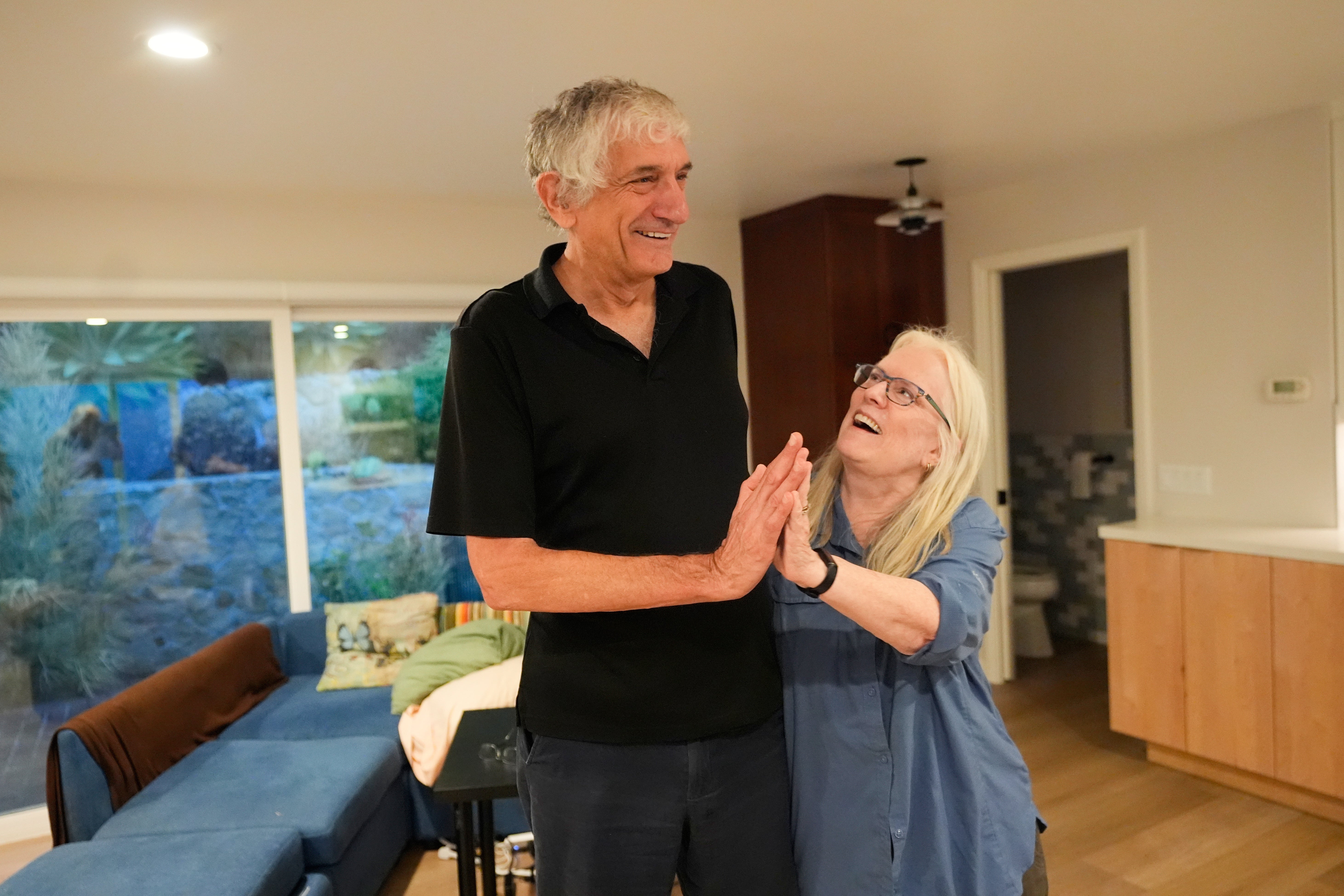 John Martinis stands with his wife Jean in their living room after winning the Nobel Prize in Physics for his work on quantum tunneling on Tuesday, Oct. 7, 2025, in Santa Barbara, Calif. (AP Photo/Mark J. Terrill)