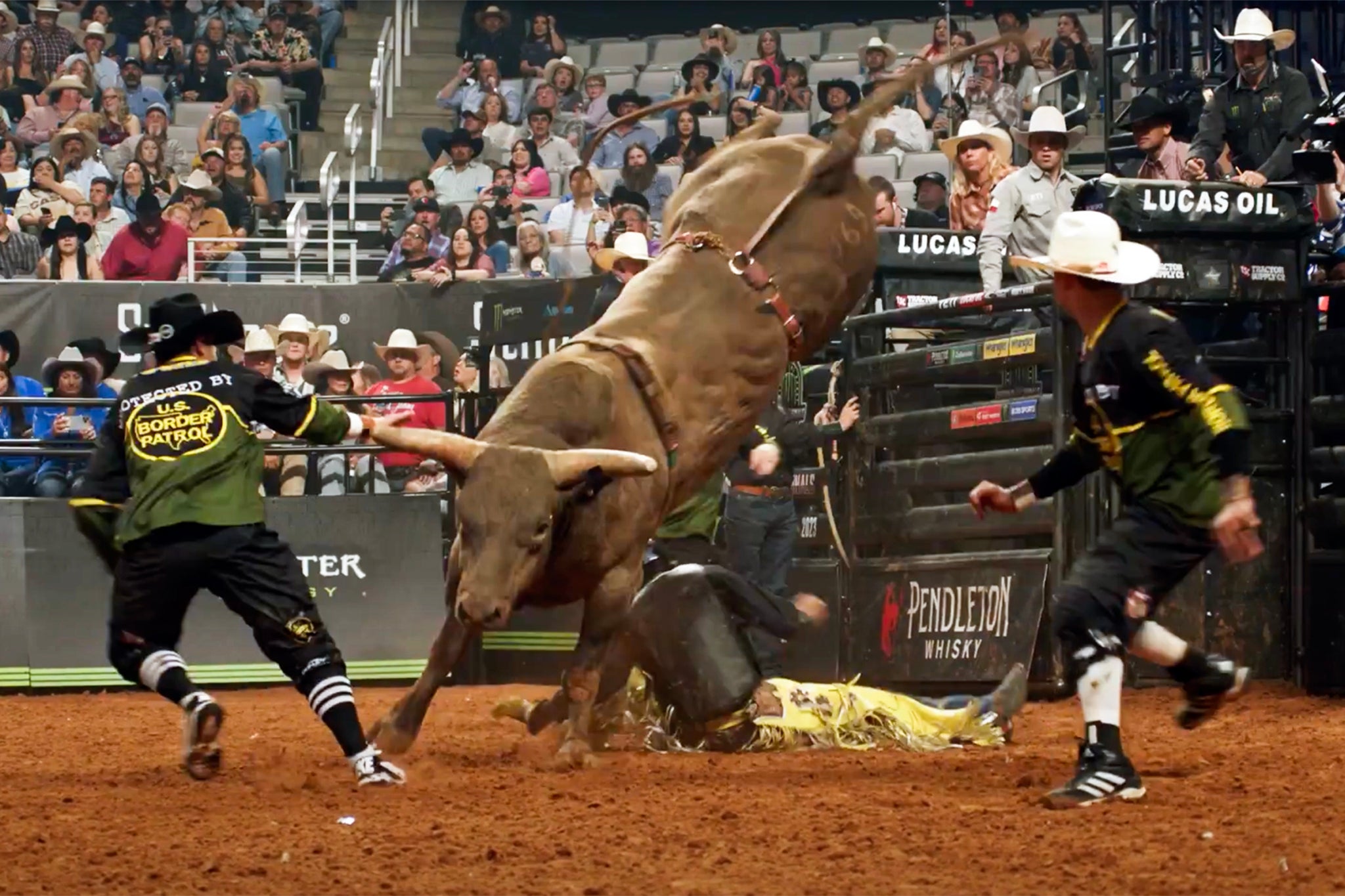 Rodeo riders wearing Border Patrol emblazoned shirts