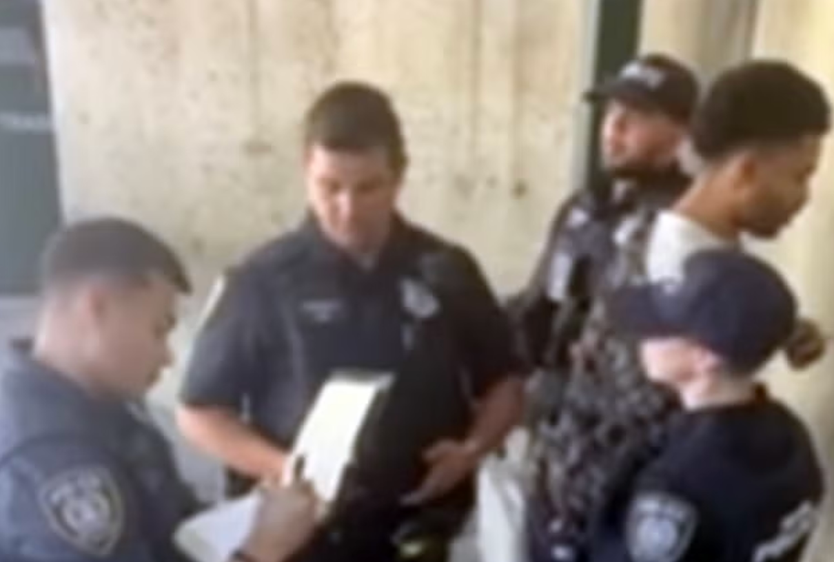 O'Keefe was pictured being stood against a wall after being removed from the train