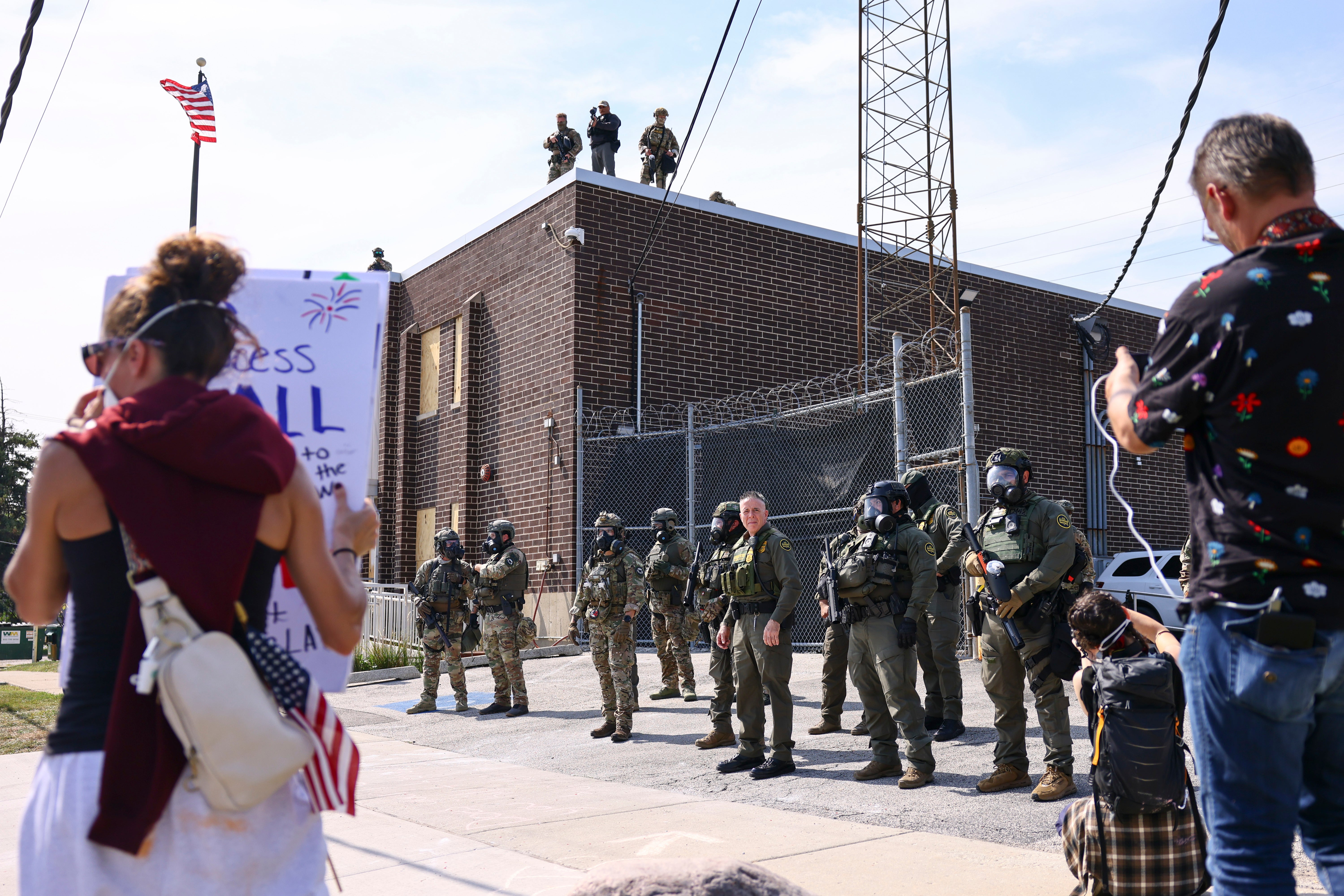 ICE agents above a Broadview facility outside Chicago fired pepper ball rounds at protesters, including Black, September 19
