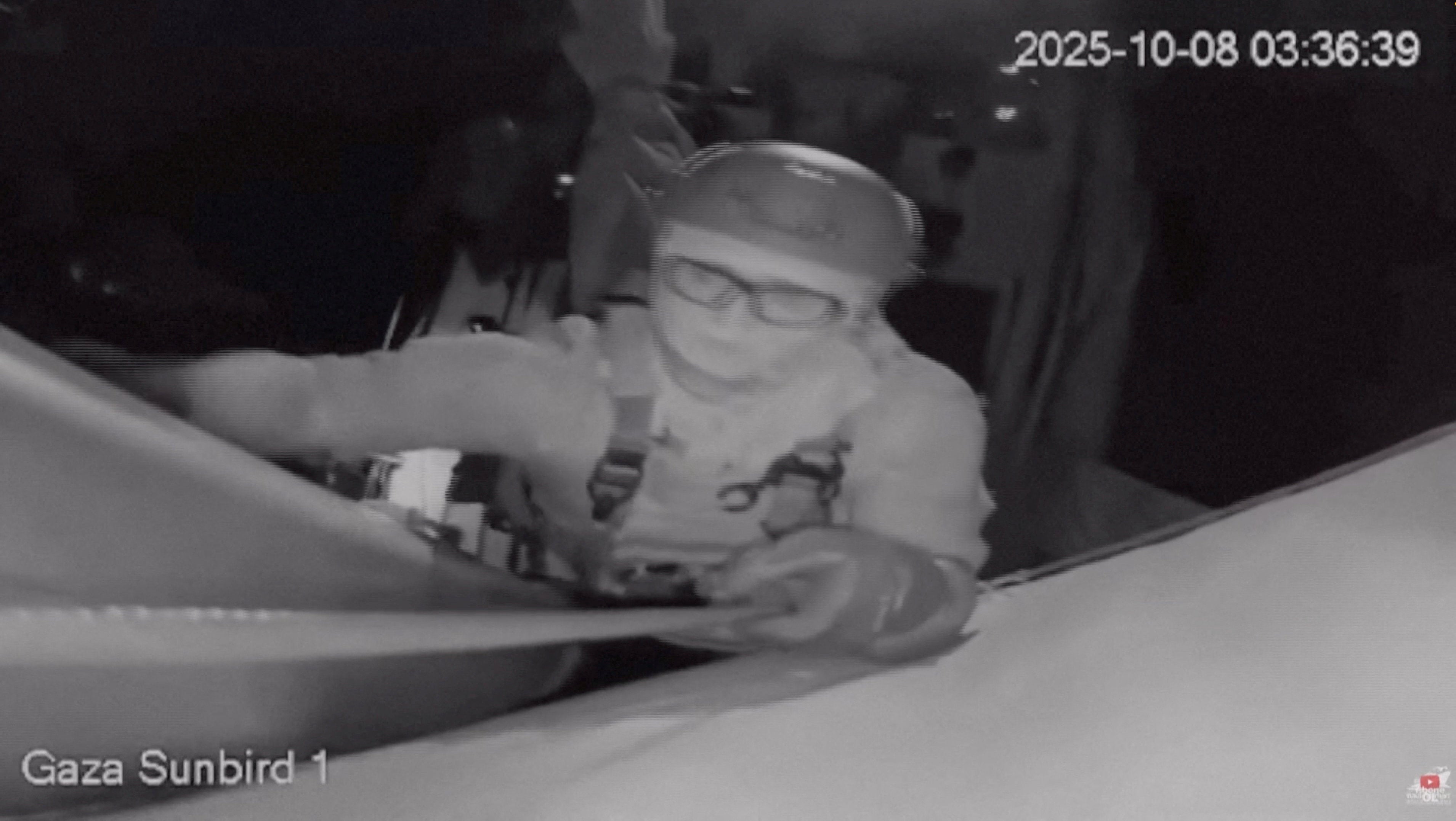 A screengrab from a live footage video shows an Israeli soldier smashing the CCTV camera of a Gaza-bound vessel