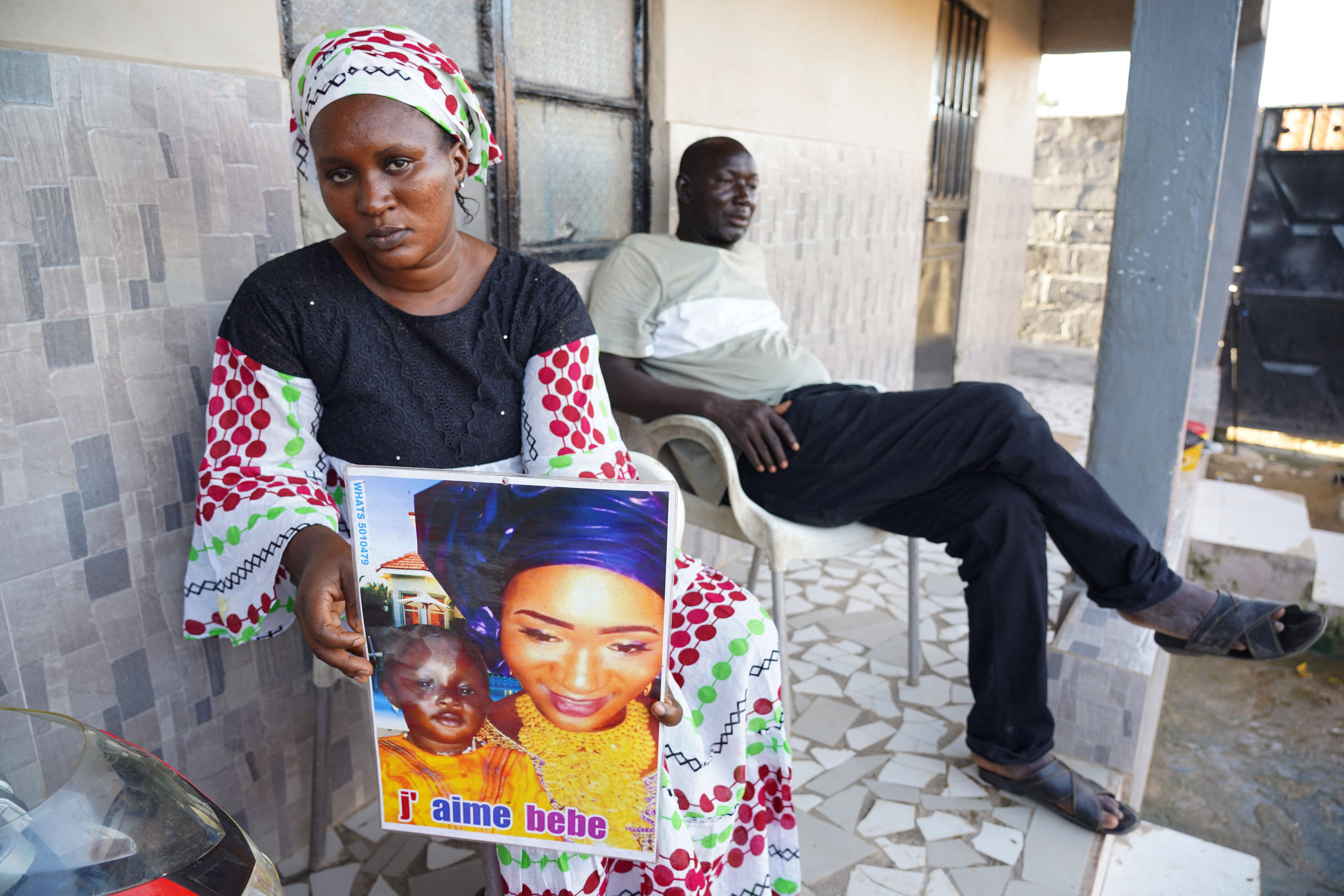 Mariama Kuyateh holds up a picture of her late son Musawhom who died from acute kidney failure in 2022