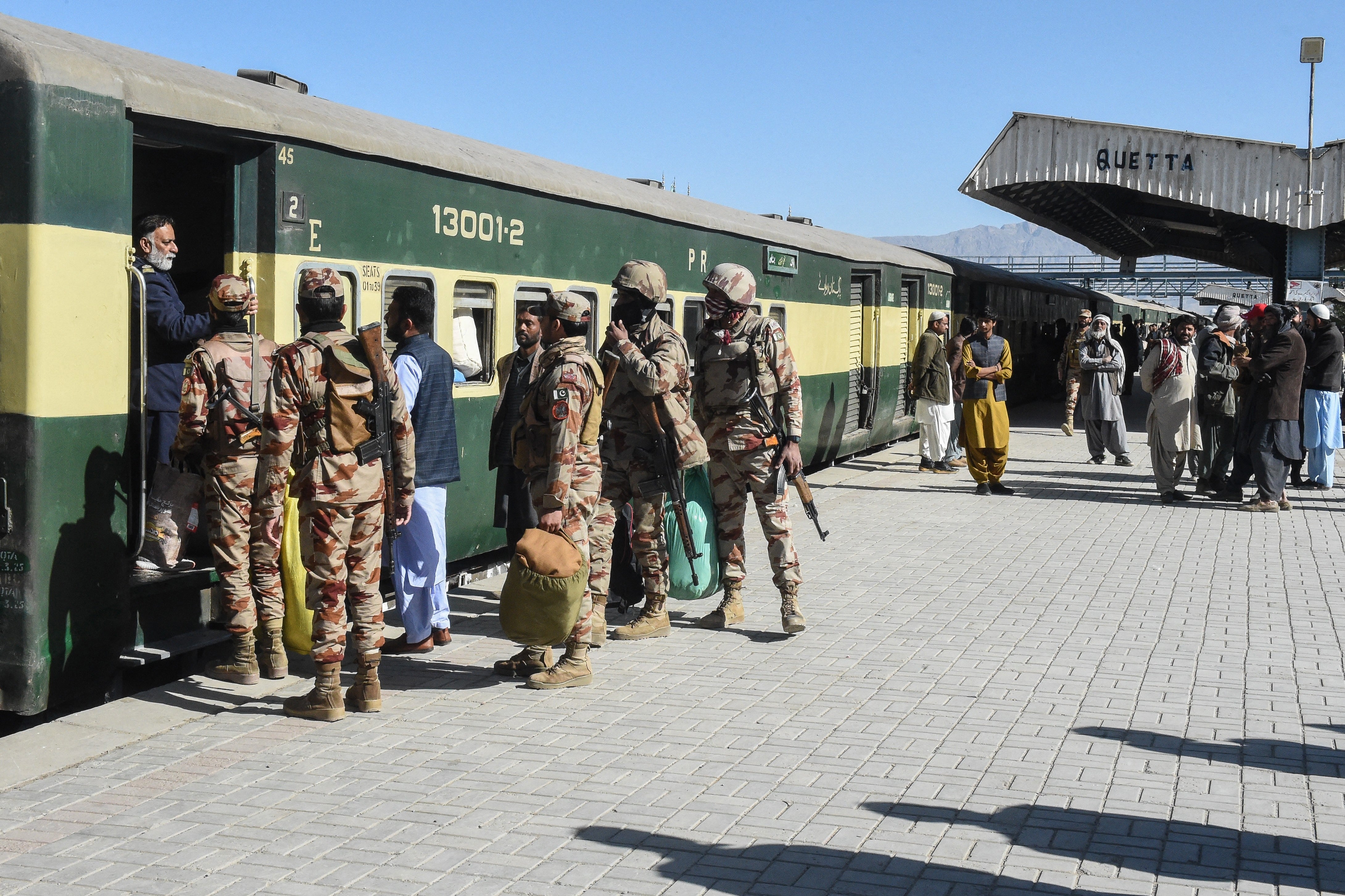 Pakistani Army personnel board the Jaffar Express passenger train as it resumes its services after an attack by ethnic Baloch separatists
