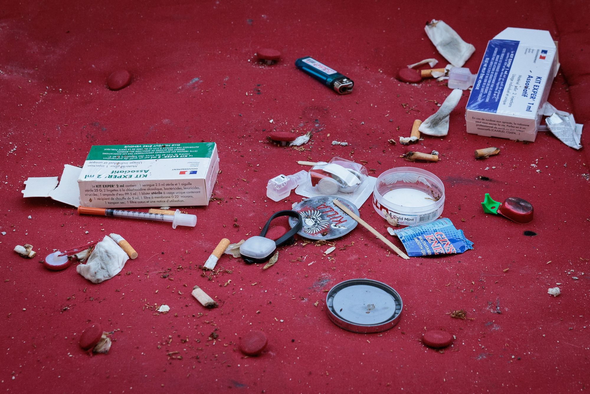 Photograph shows syringes used by drug addicts and boxes containing HIV and hepatitis prevention tool, thrown on a mattress