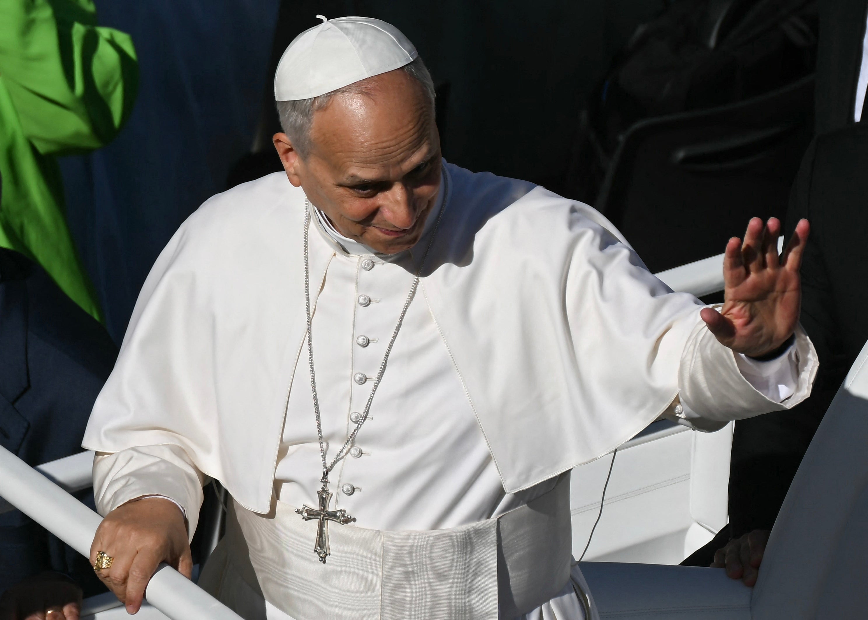 Pope Leo XIV waves to pilgrims as he tours in the Popemobile
