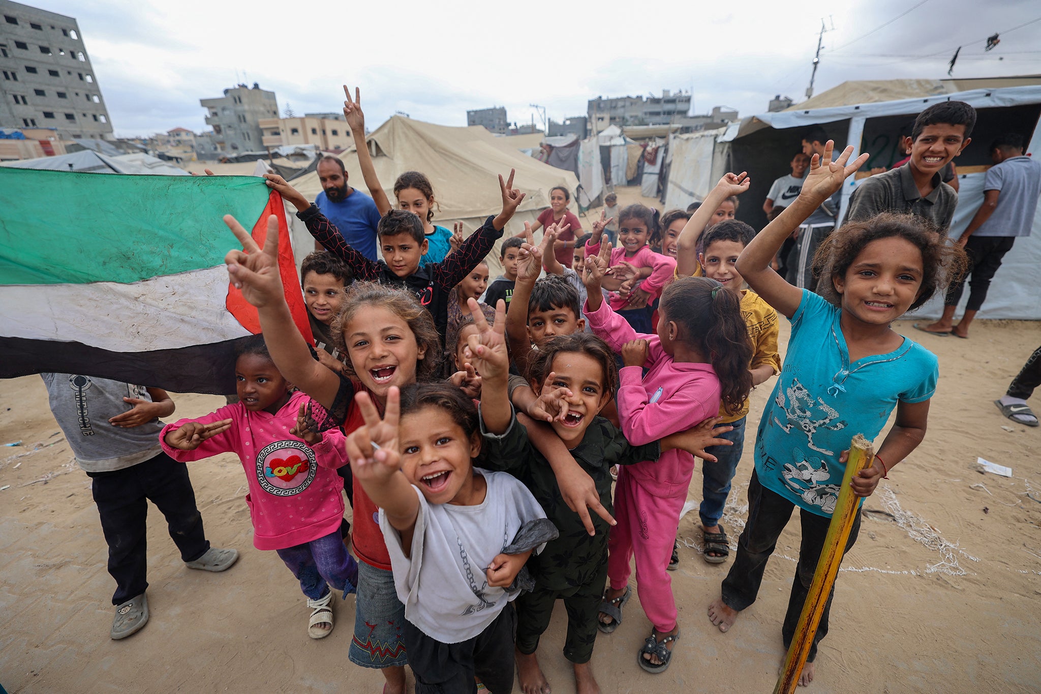 Children in Gaza celebrating at a camp for displaced people in Nuseirat, on the Gaza Strip, following news of a new Gaza ceasefire deal