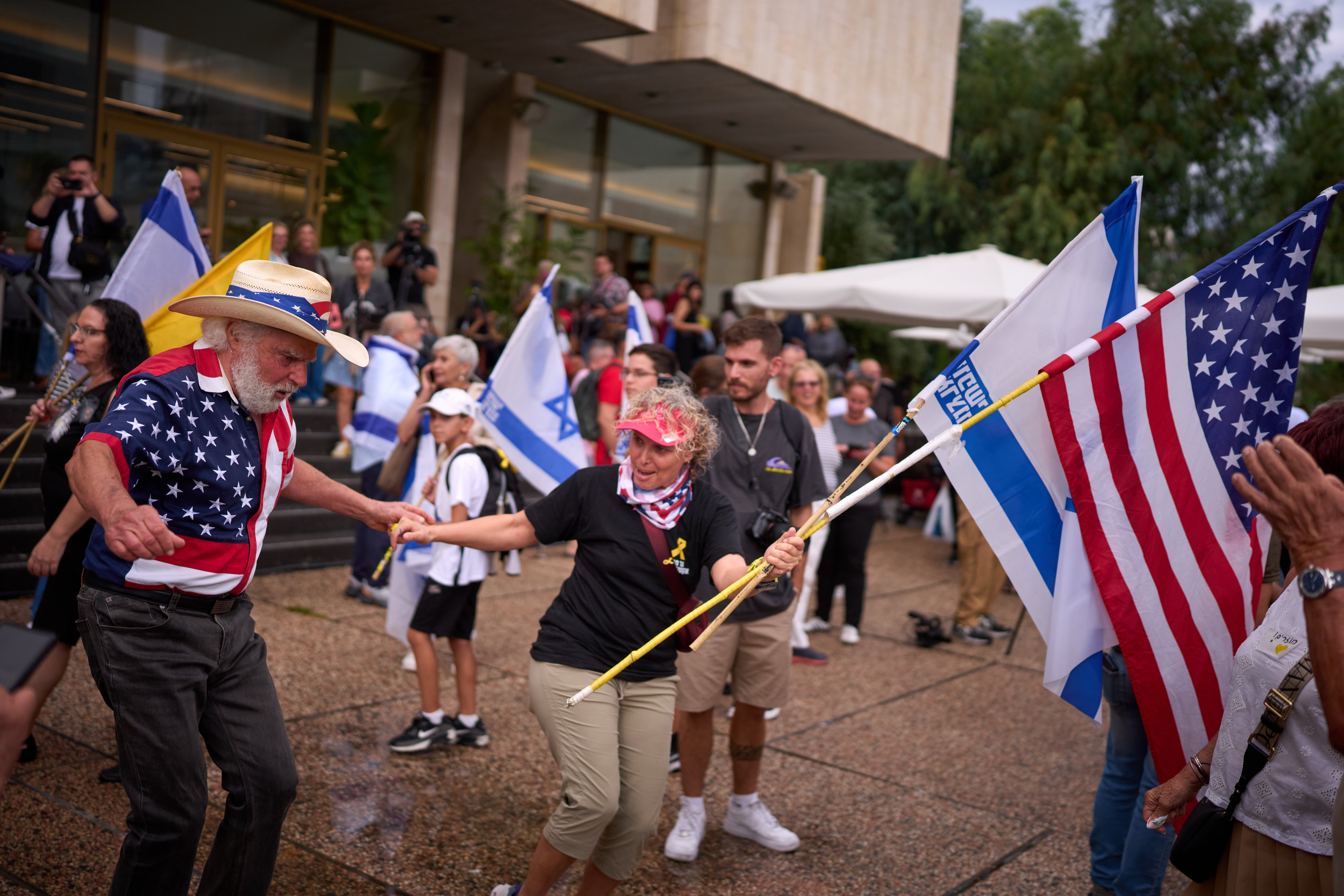 People celebrate the ceasefire agreement at ‘Hostages Square’ in Tel Aviv, Israel, 9 October