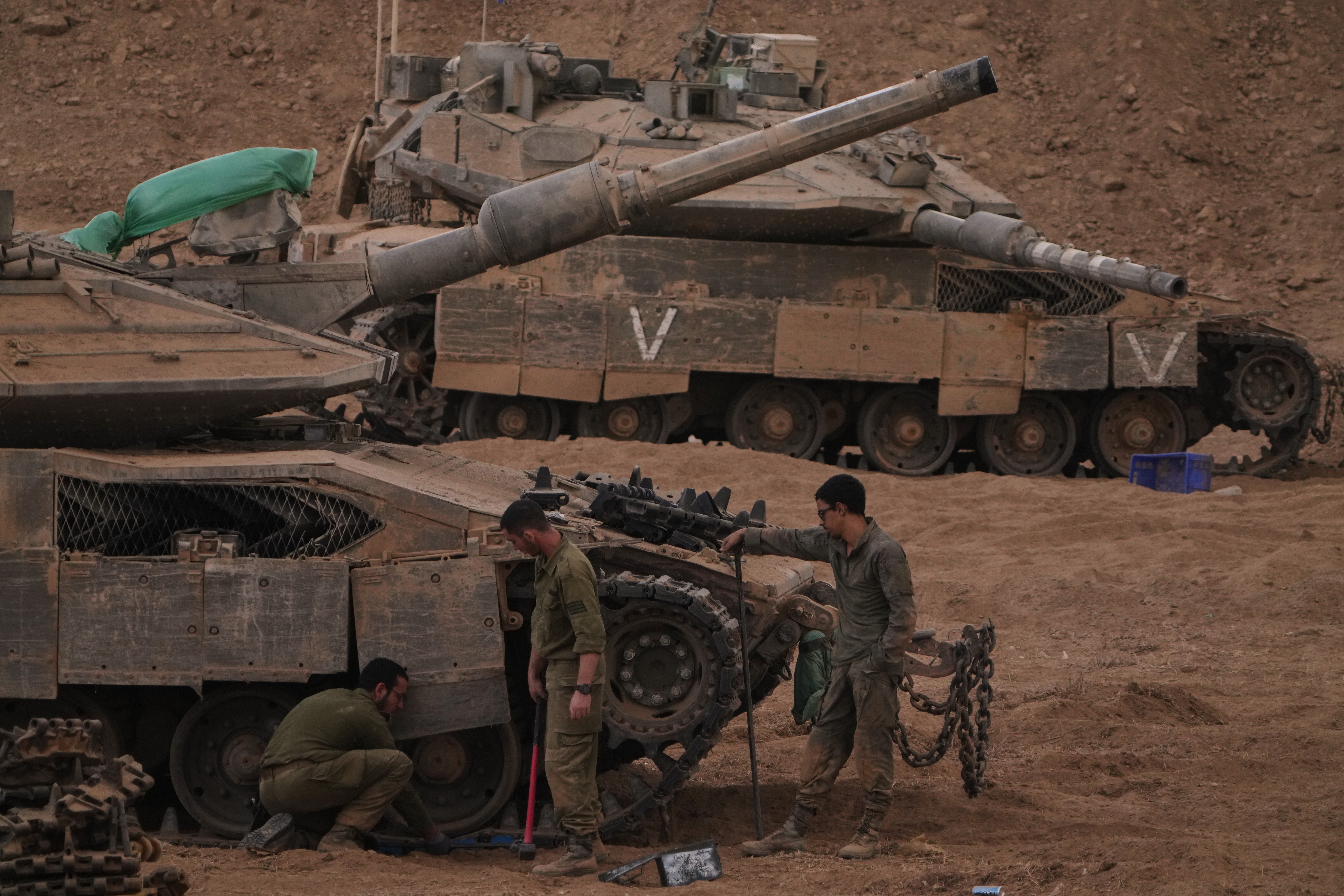 Israeli soldiers near the Israeli-Gaza border on Thursday, following the announcement that Israel and Hamas have agreed to the first phase of a peace plan