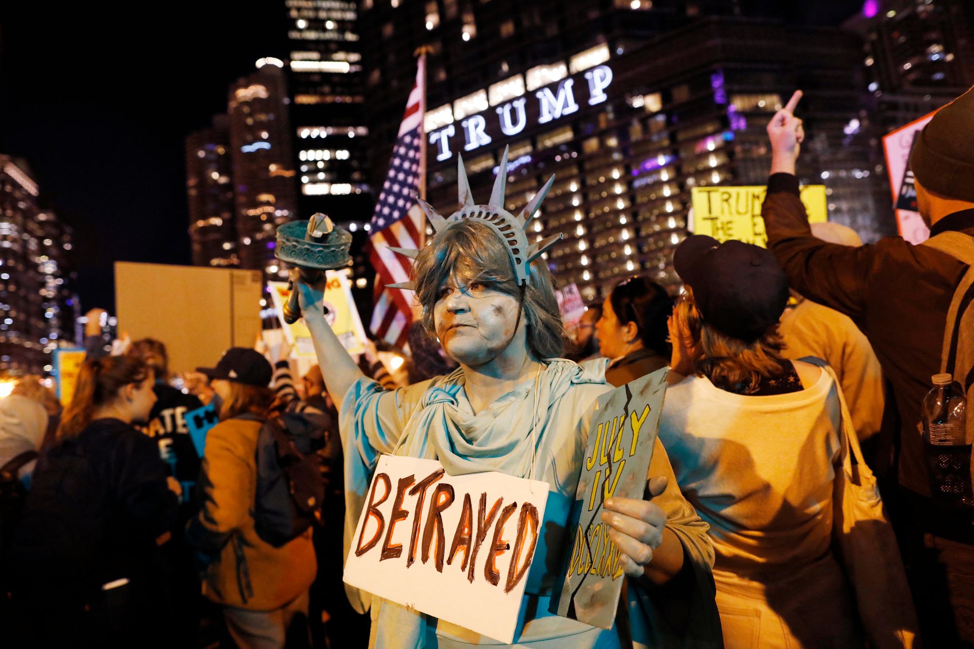 A protester, wearing a Statue of Liberty costume, attends a demonstration against the arrival of the Texas National Guard and US Immigration and Customs Enforcement agents in downtown Chicago, Illinois