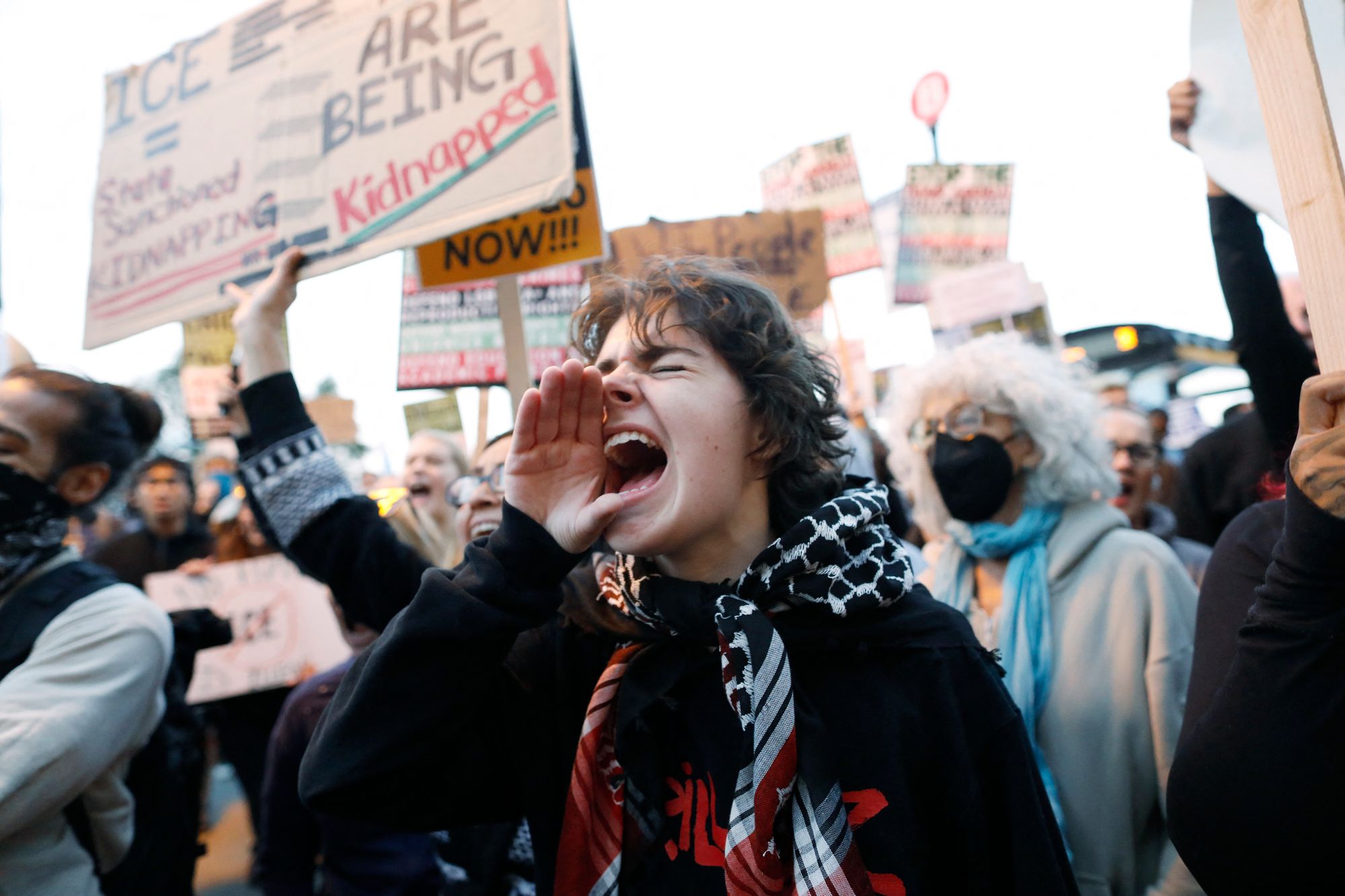 People shout slogans while protesting the arrival of the Texas National Guard and US Immigration and Customs Enforcement agents in downtown Chicago, Illinois