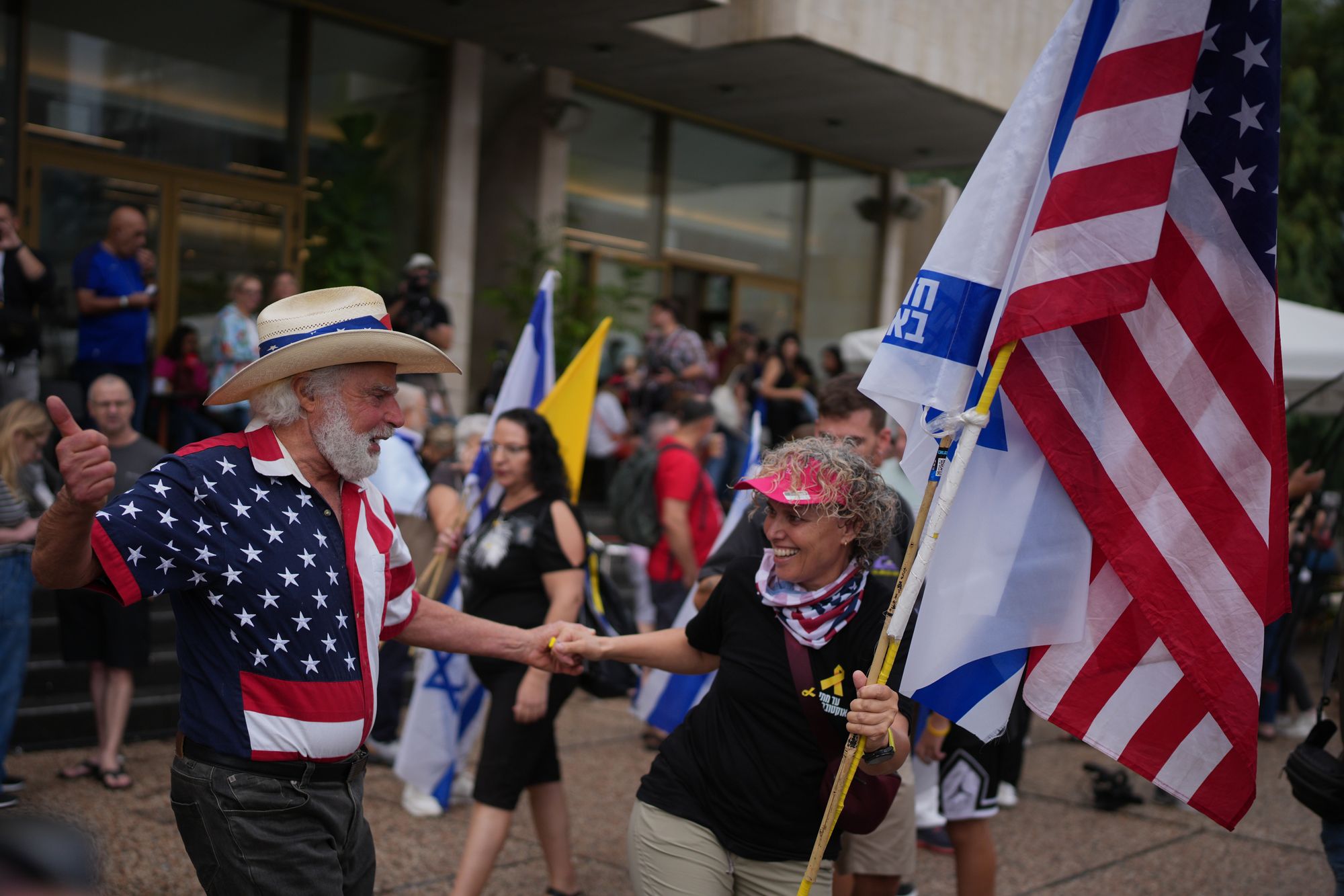 People dance in Tel Aviv as they celebrate following the announcement that Israel and Hamas have agreed to the first phase of a peace plan