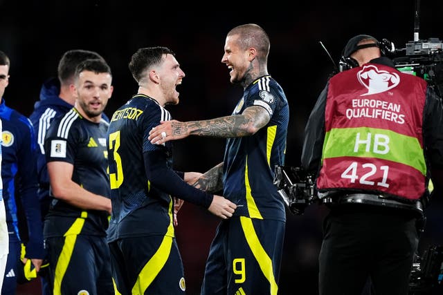 <p>Andy Robertson celebrates with Lyndon Dykes after Scotland’s 3-1 win </p>