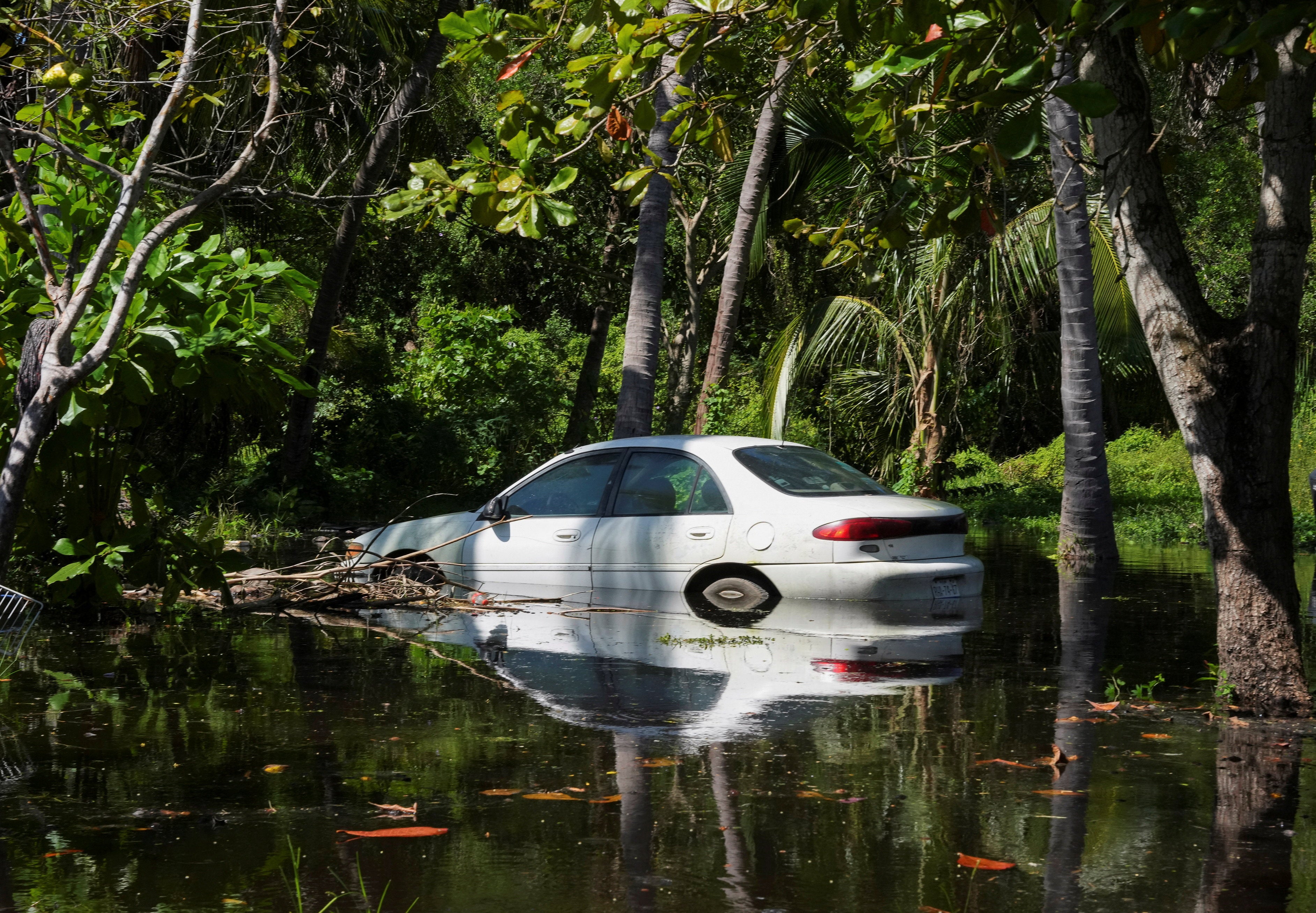 A car partially covered in water near the beach after rising waves flooded the area as Hurricane Priscilla strengthed in Nayarit, Mexico a few days ago