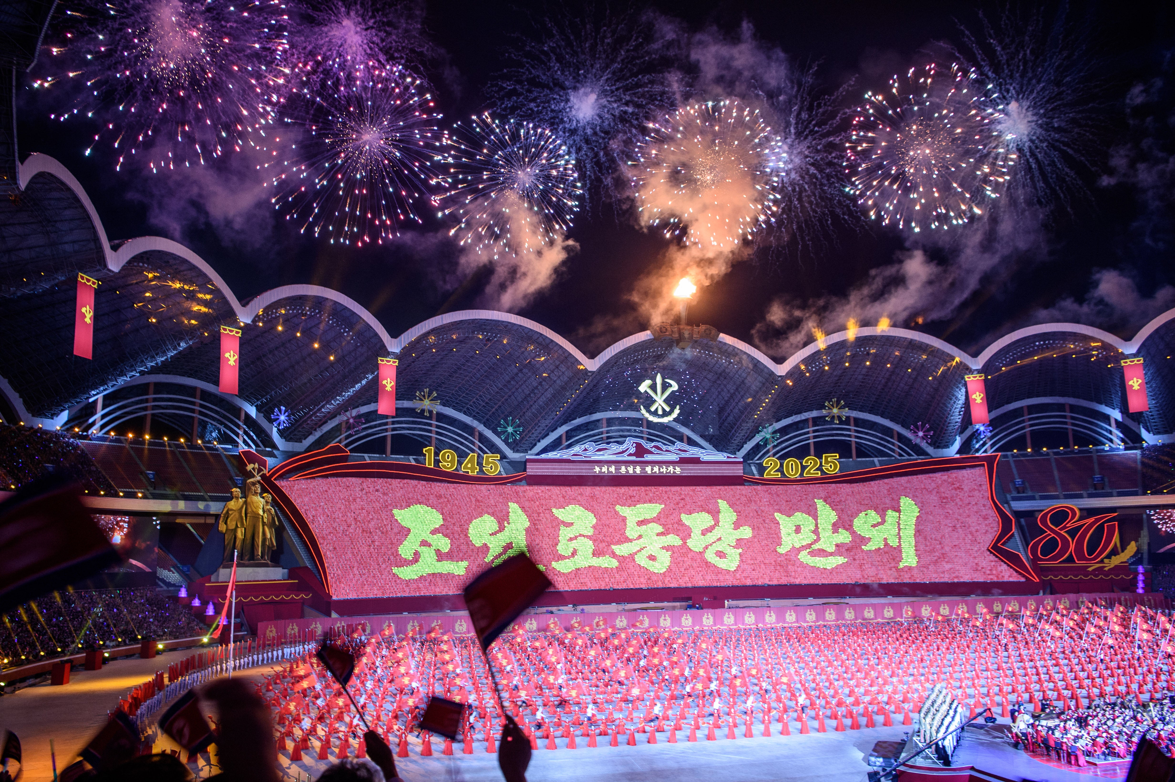 <p>Fireworks light up the sky as participants take part in the ‘Long Live the Workers’ Party of Korea’ performance to celebrate the 80th founding anniversary of the Workers’ Party of Korea at the May Day Stadium in Pyongyang on 9 October 2025</p>