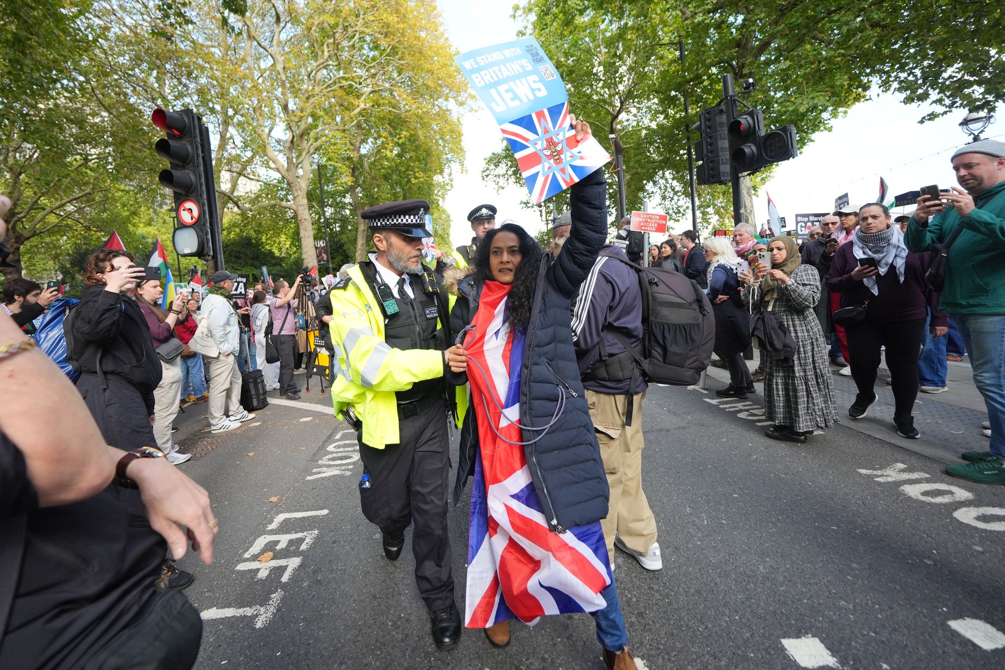 A police officer is seen with a demonstrator from Our Fight, a pro-Israel organisation, at the pro-Palestine march