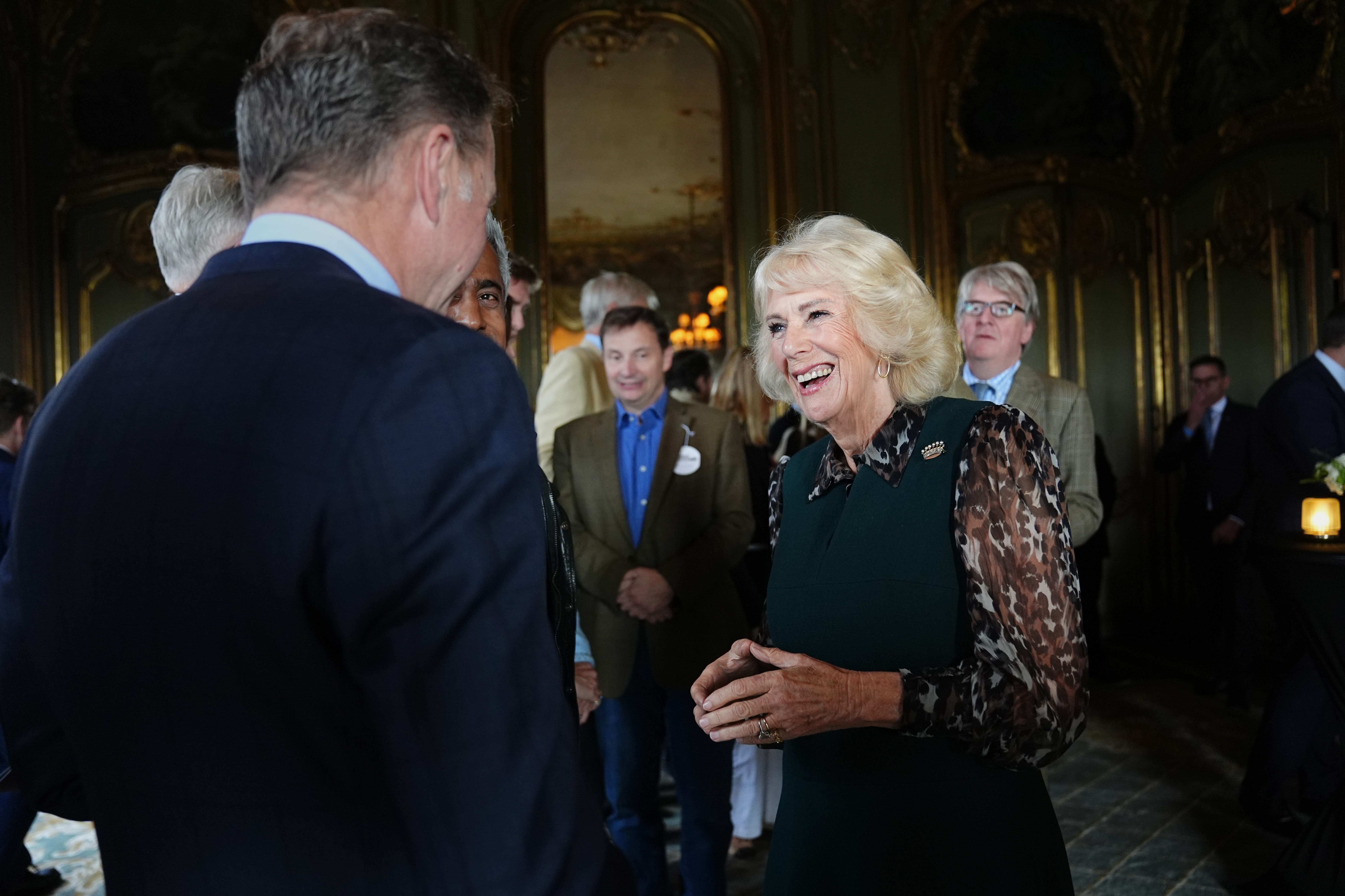 Queen Camilla speaking to guests at a reception in Cliveden House (Jacob King/PA)