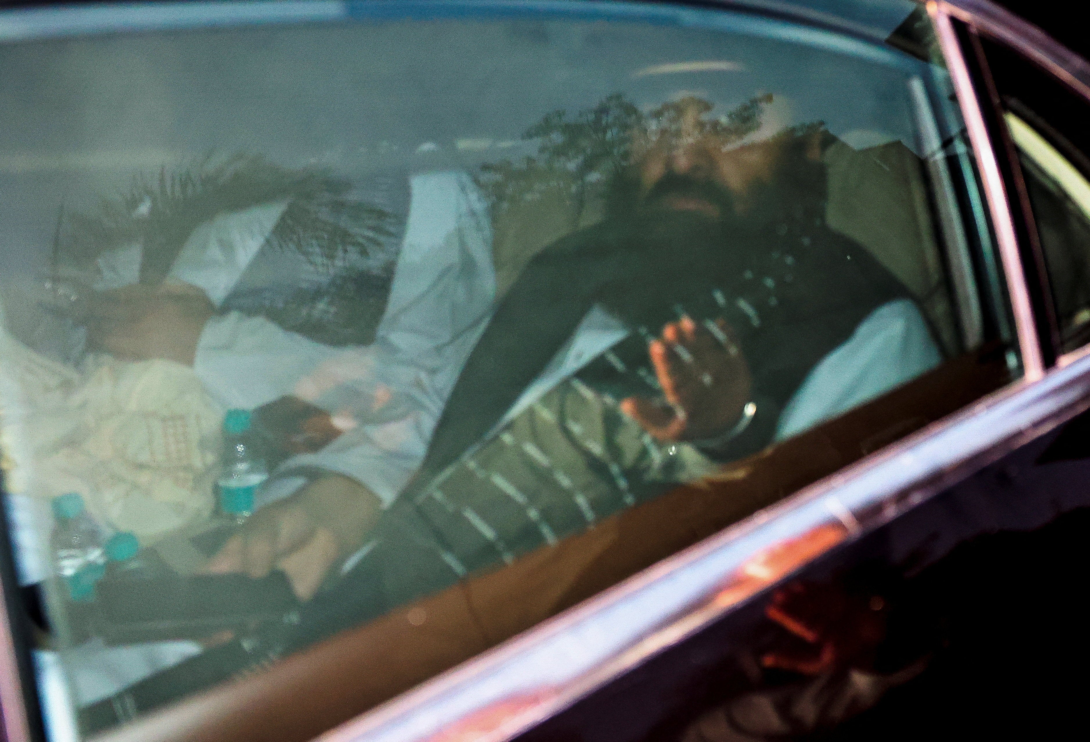 Taliban foreign minister Mawlawi Amir Khan Muttaqi sits in a car as he leaves the building of Vivekananda International Foundation after meetings in New Delhi