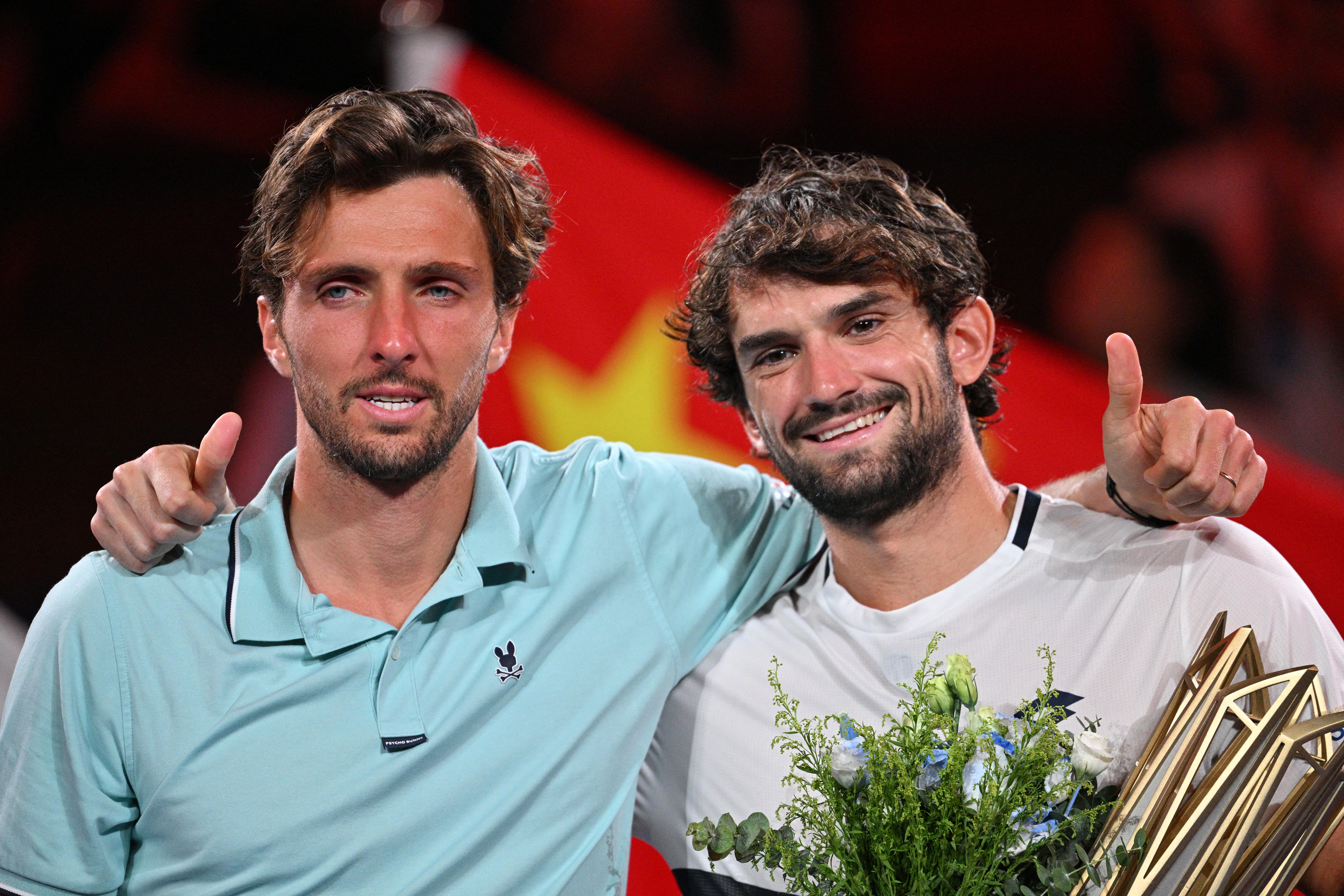 Valentin Vacherot (right) holds the trophy after defeating his cousin Arthur Rinderknech in the final